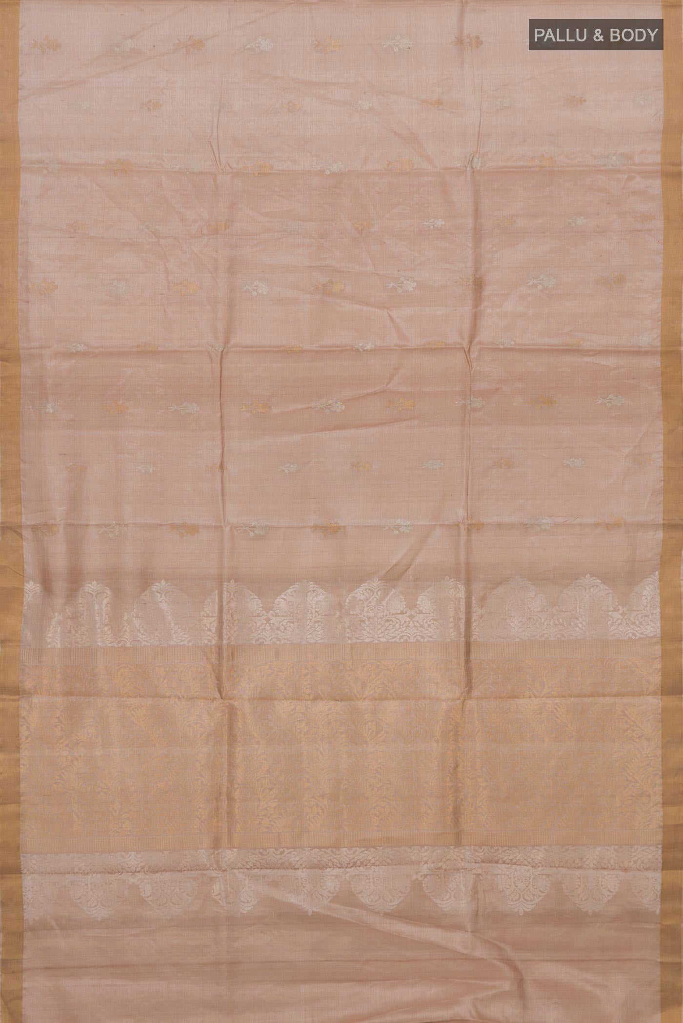 Flat view of Beige Tussar Silk Saree with Zari Butta on the body and Thin Zari Line. 