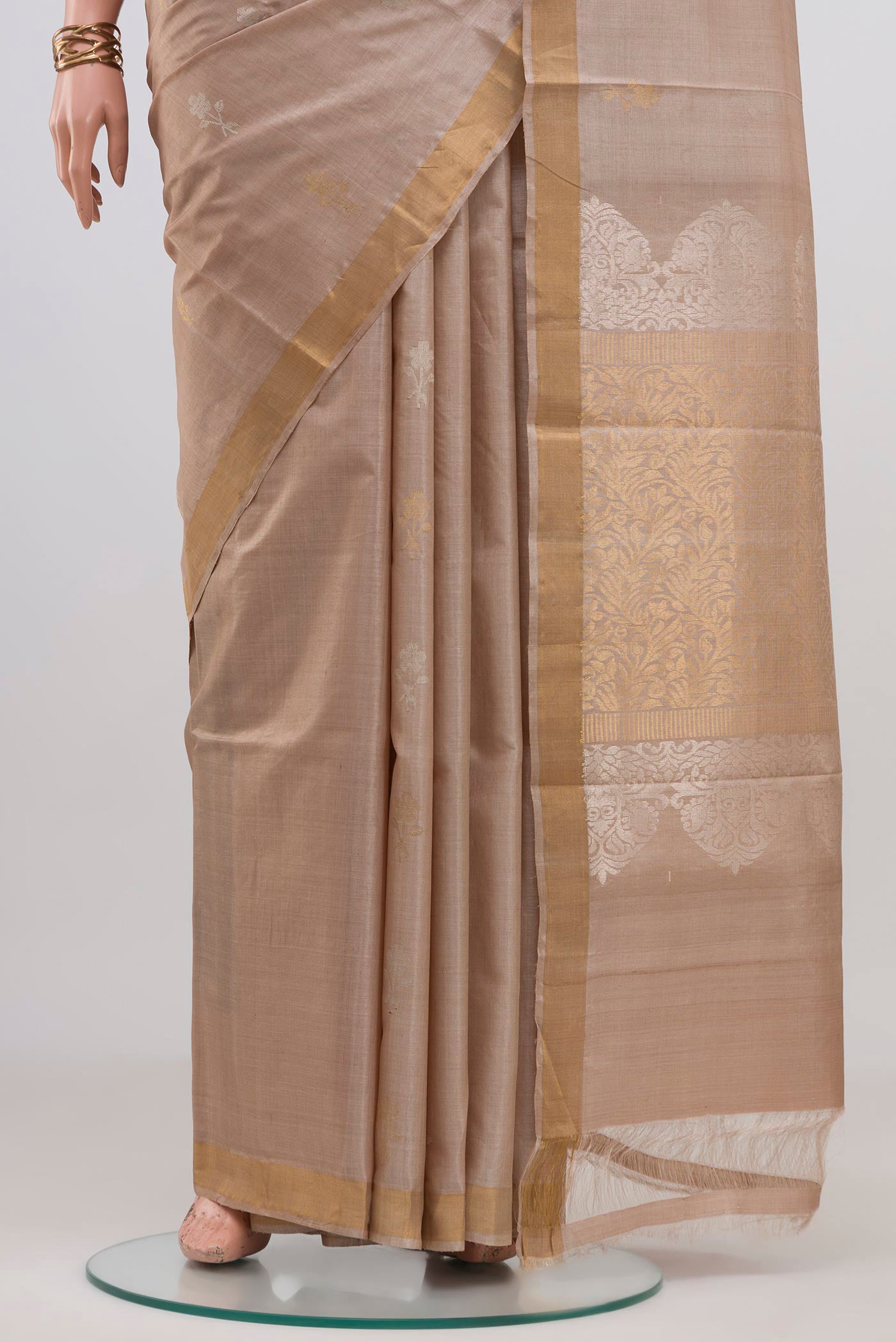 Pleats and pallu of Beige Tussar Silk Saree with Zari Butta on the body and Thin Zari Line. 