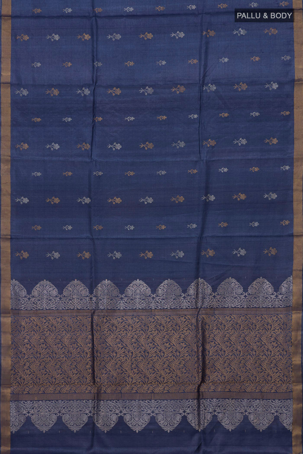 Flat view of Blue Grey Tussar Silk Saree with Zari Butta on the body and Zari Border. 