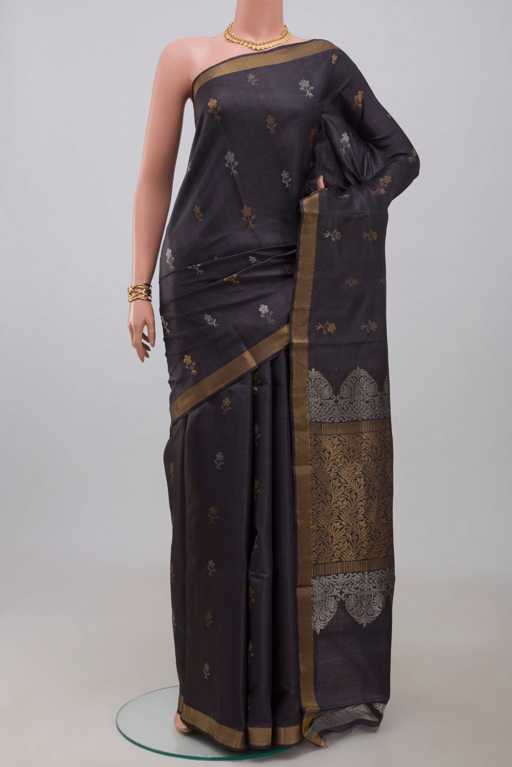 Grey Tussar Silk Saree with Zari Butta on the body and Zari Border.  displayed on a mannequin