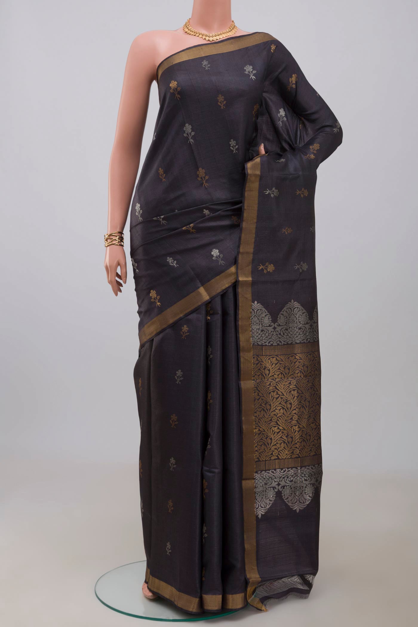 Grey Tussar Silk Saree with Zari Butta on the body and Zari Border.  displayed on a mannequin
