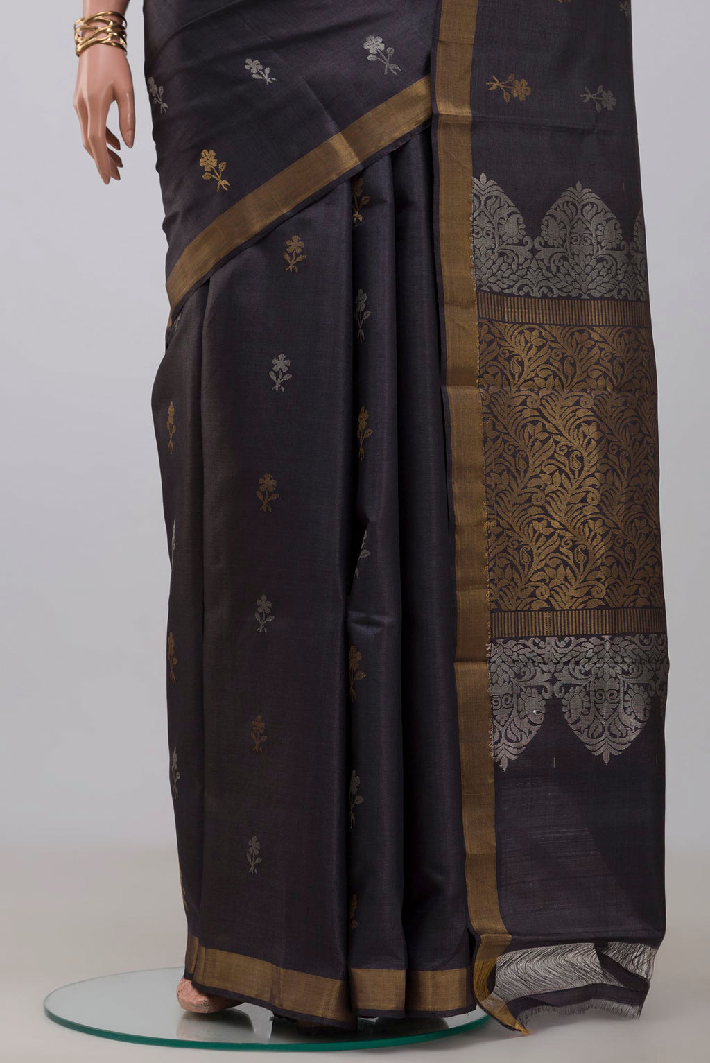 Pleats and pallu of Grey Tussar Silk Saree with Zari Butta on the body and Zari Border. 