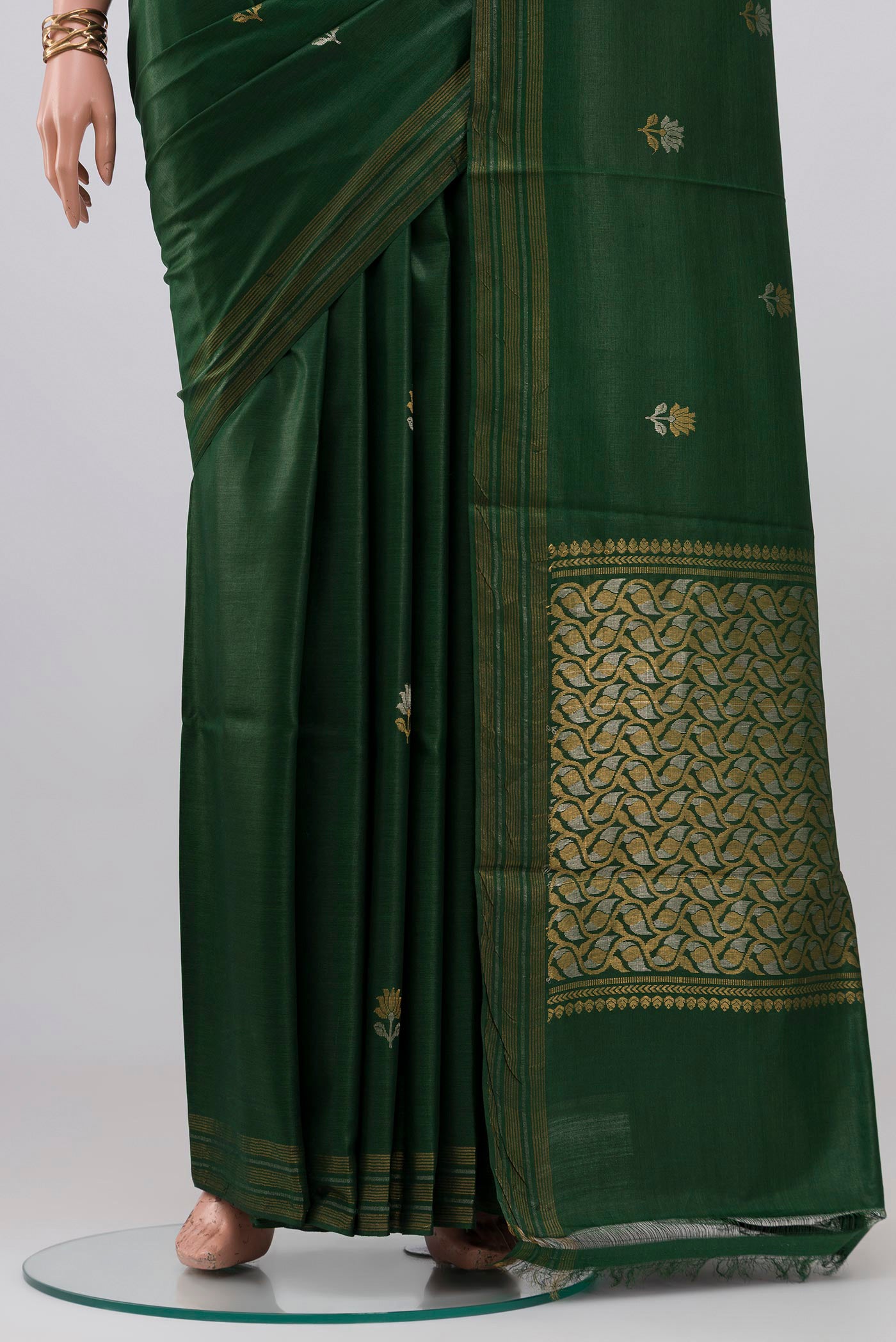 Pleats and pallu of Bottle Green Tussar Silk Saree with Zari Butta on the body and Zari Border. 