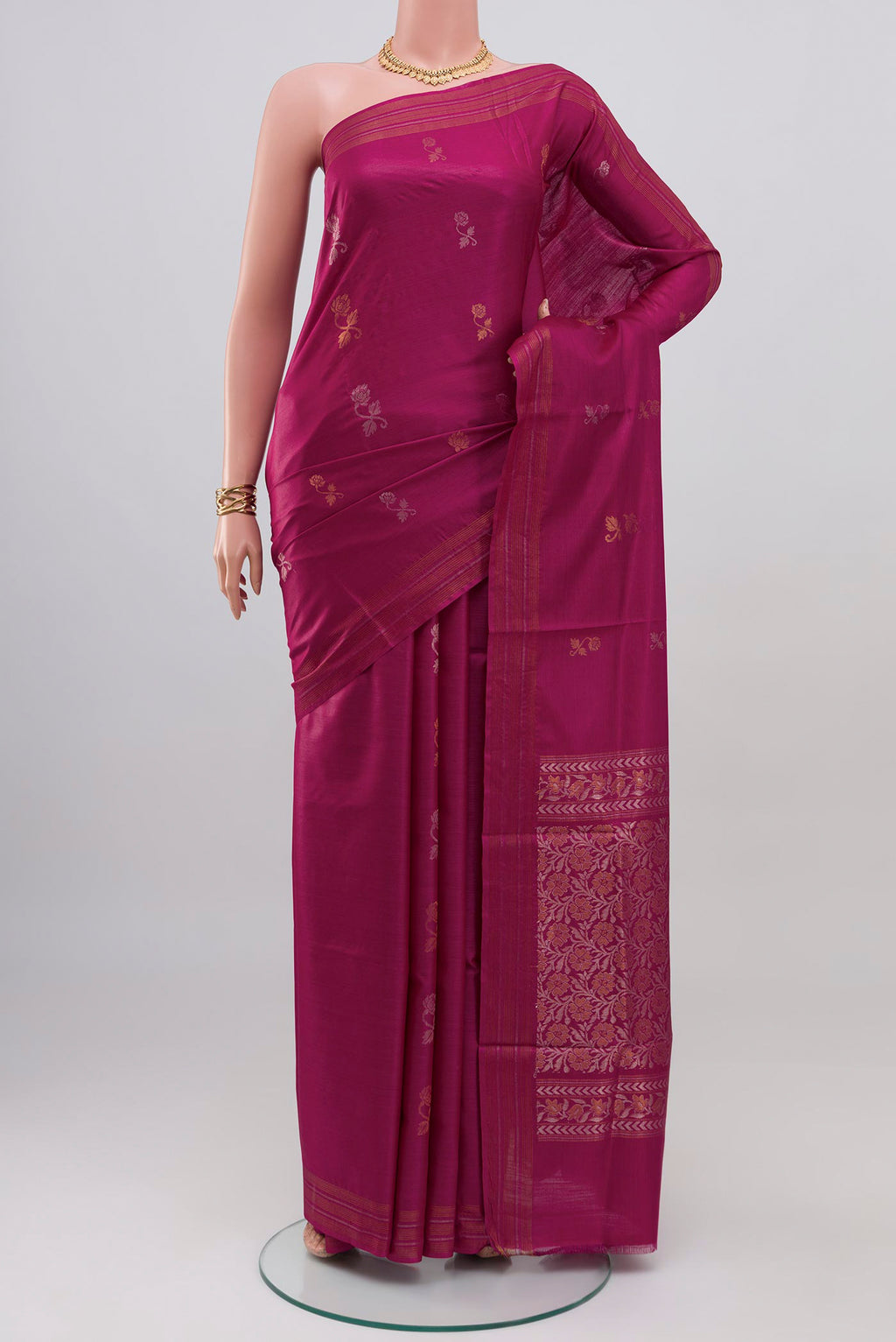 Magenta Tussar Silk Saree with Zari Butta on the body and Thin Zari Line.  displayed on a mannequin