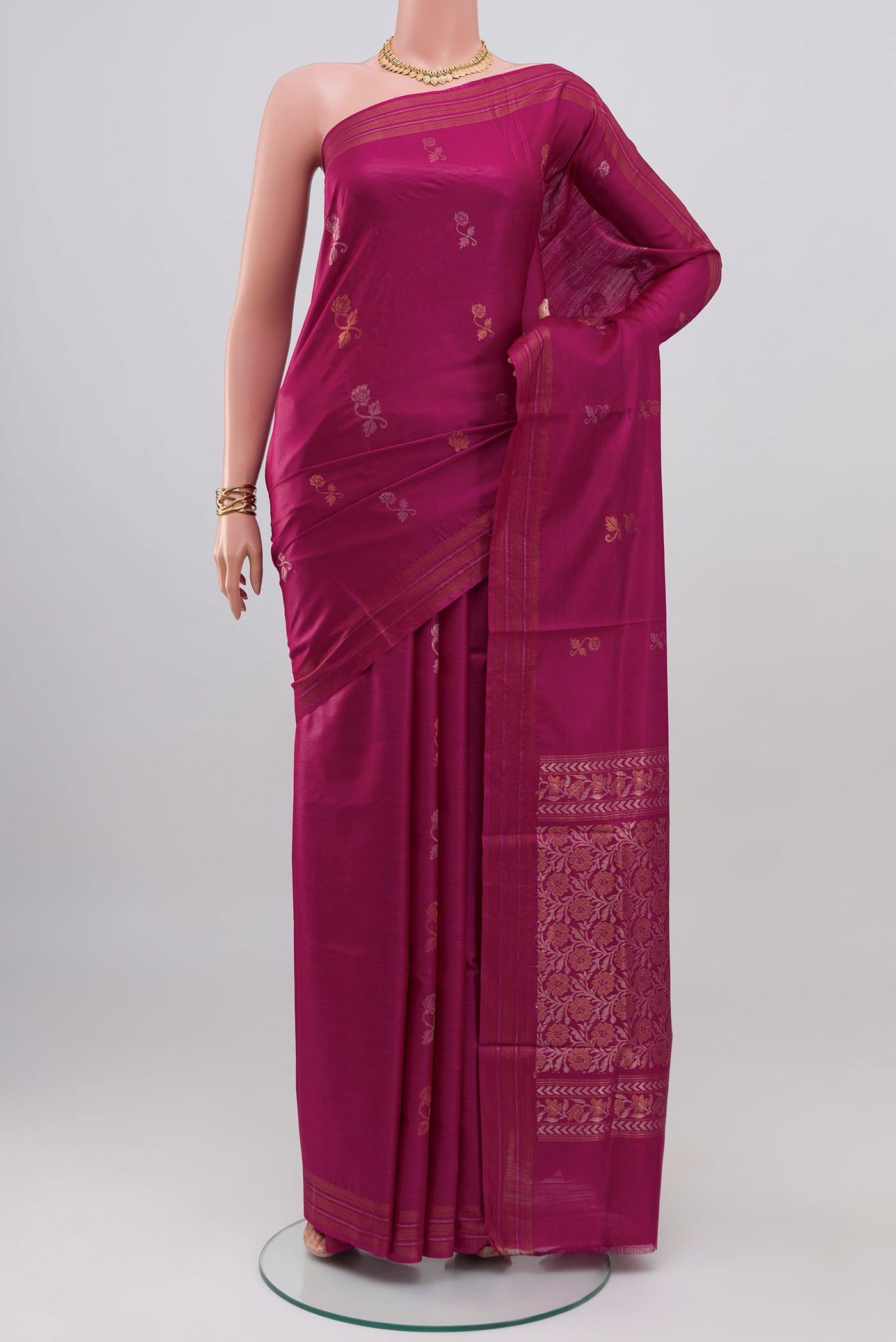 Magenta Tussar Silk Saree with Zari Butta on the body and Thin Zari Line.  displayed on a mannequin