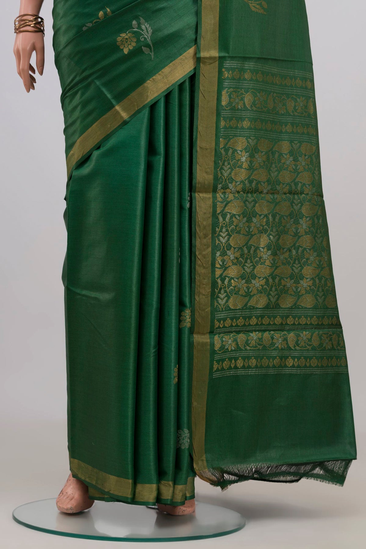 Pleats and pallu of Green Tussar Silk Saree with Zari Butta on the body and Zari Border. 