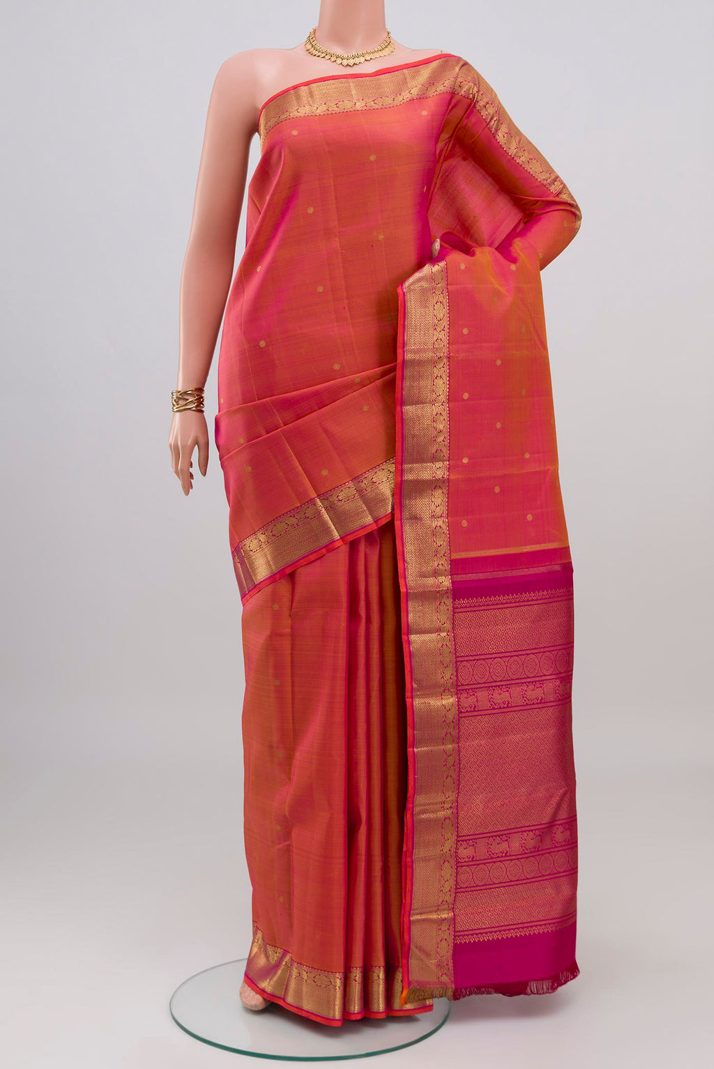 Pure Silk Pure Zari Pinkish Yellow Dual Tone Kanjivaram Saree with Zari Butta on the body and Zari Border.  displayed on a mannequin
