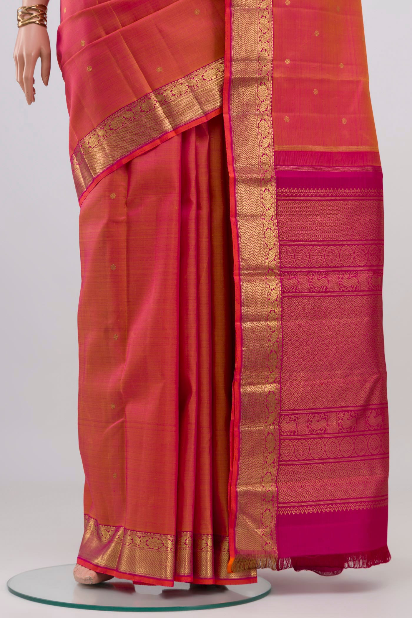 Pleats and pallu of Pure Silk Pure Zari Pinkish Yellow Dual Tone Kanjivaram Saree with Zari Butta on the body and Zari Border. 
