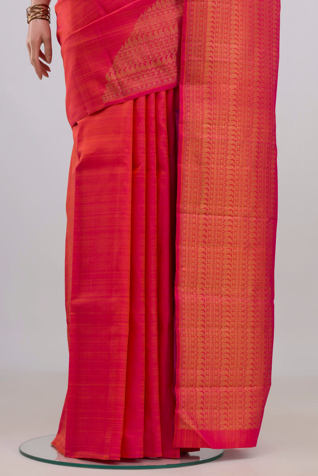 Pleats and pallu of Pure Silk Pure Zari Brick Orange Kanchipuram Saree with Plain Body and Rising Temple Border. 