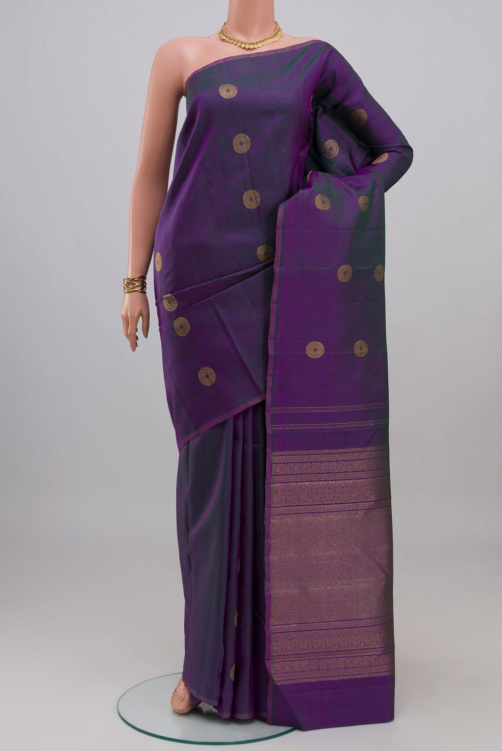 Purple Kanchipuram Silk Saree with Zari Butta on the body and Thin Zari Line.  displayed on a mannequin