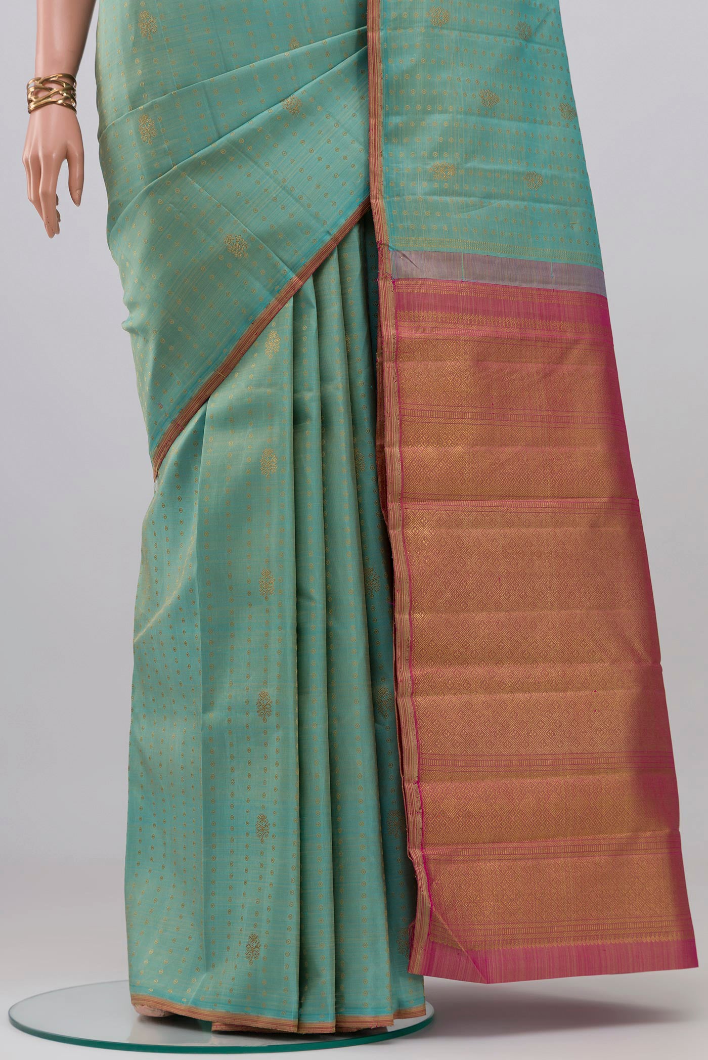 Pleats and pallu of Pure Silk Pure Zari Light Blue Kanchipuram Saree with Zari Butta on the body and Thin Zari Line. 