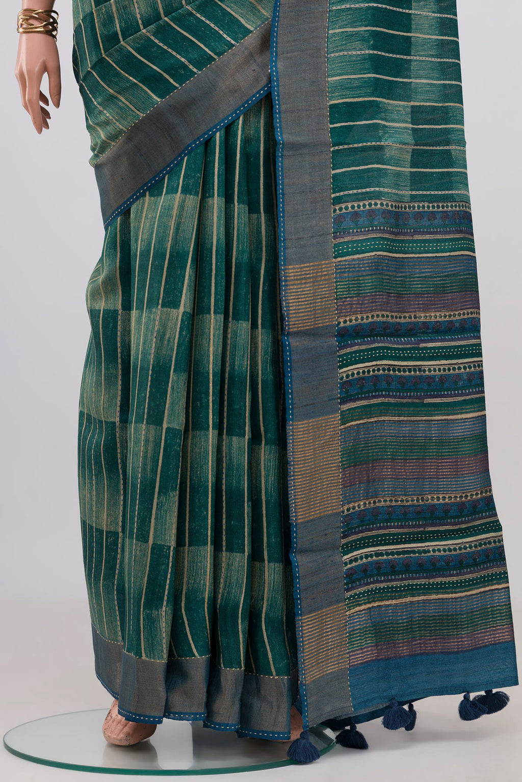 Pleats and pallu of Green Tussar Silk Saree with Printed design on the body and Zari Border. 