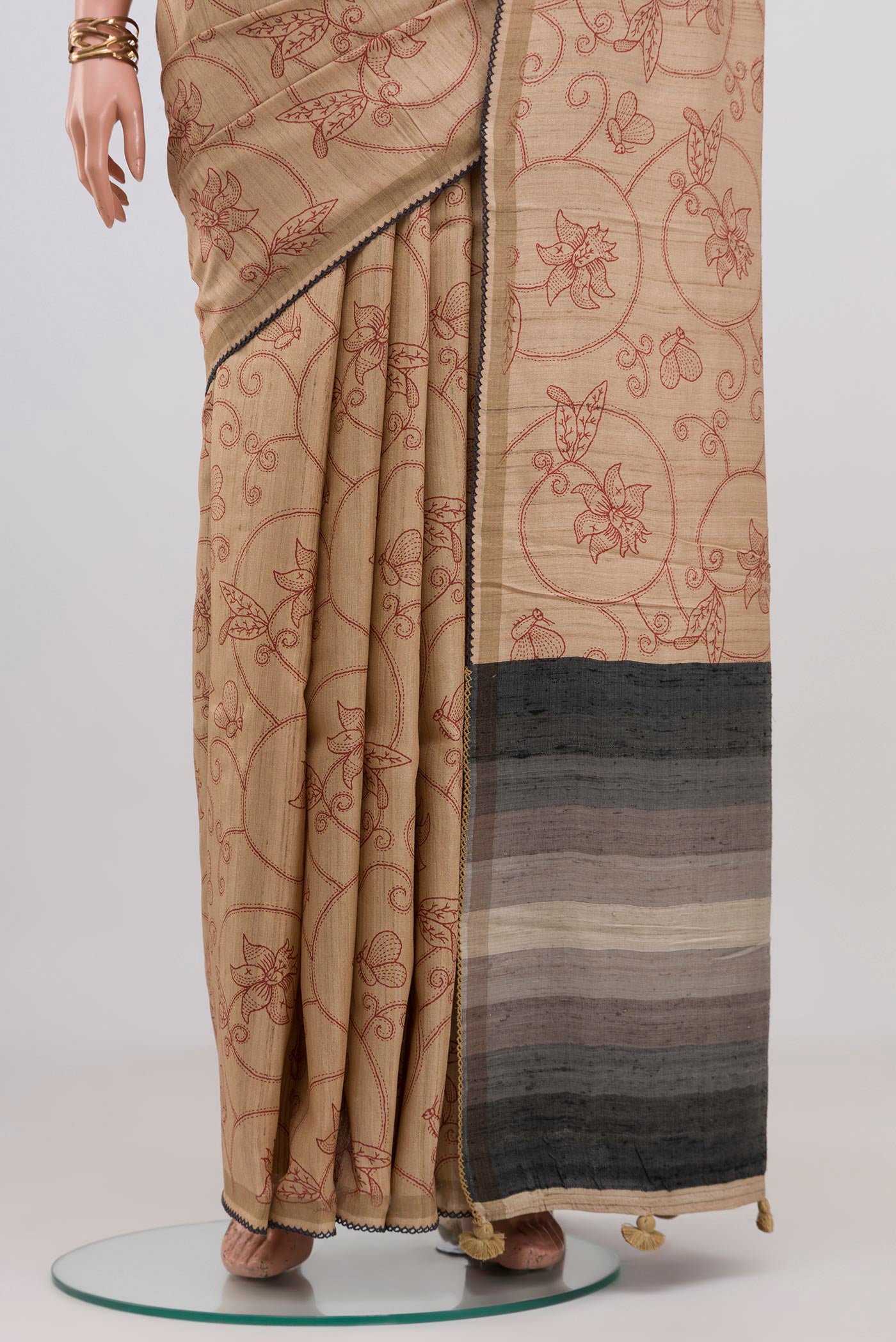 Pleats and pallu of Sandal Tussar Silk Saree with Printed design on the body and Thin Zari Line. 
