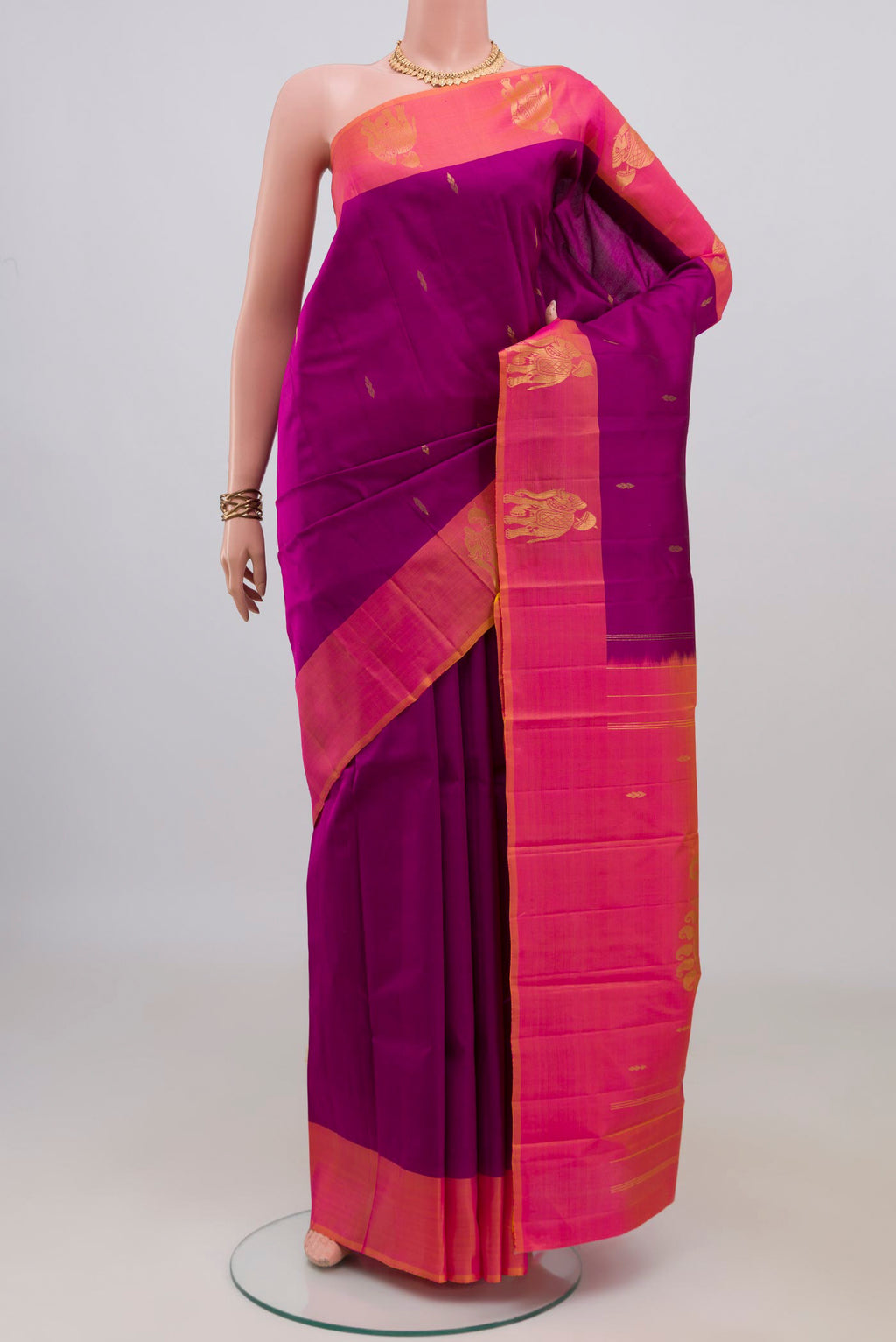 Pure Silk Magenta Kanchipuram Saree with Zari Butta on the body and Fancy Border.  displayed on a mannequin