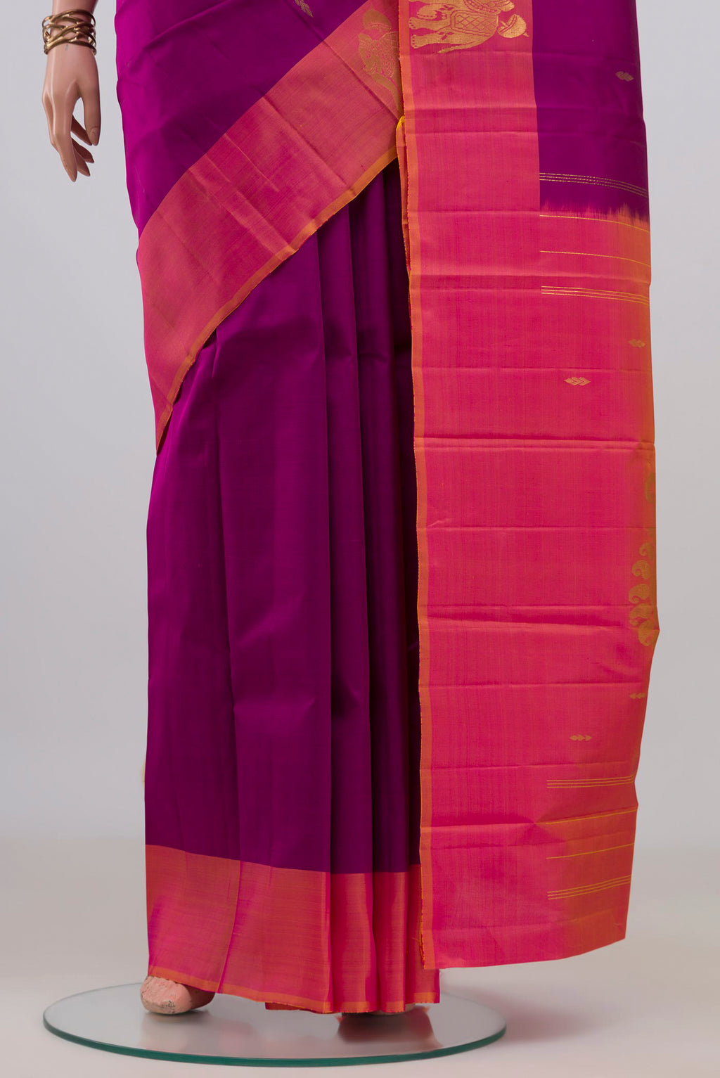 Pleats and pallu of Pure Silk Magenta Kanchipuram Saree with Zari Butta on the body and Fancy Border. 
