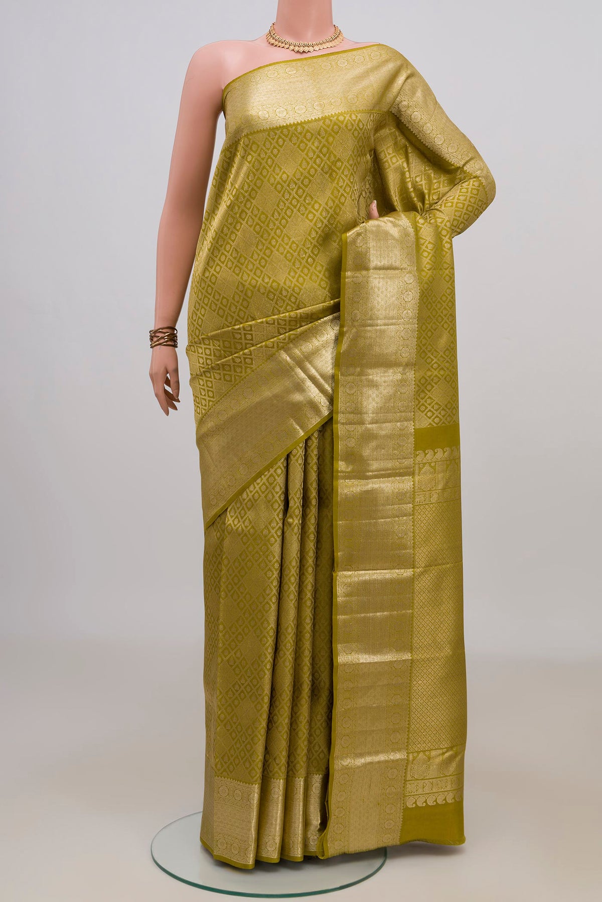 Pure Silk Mehandi Green Kanchipuram Saree with Zari Brocade on the body and Zari Border.  displayed on a mannequin