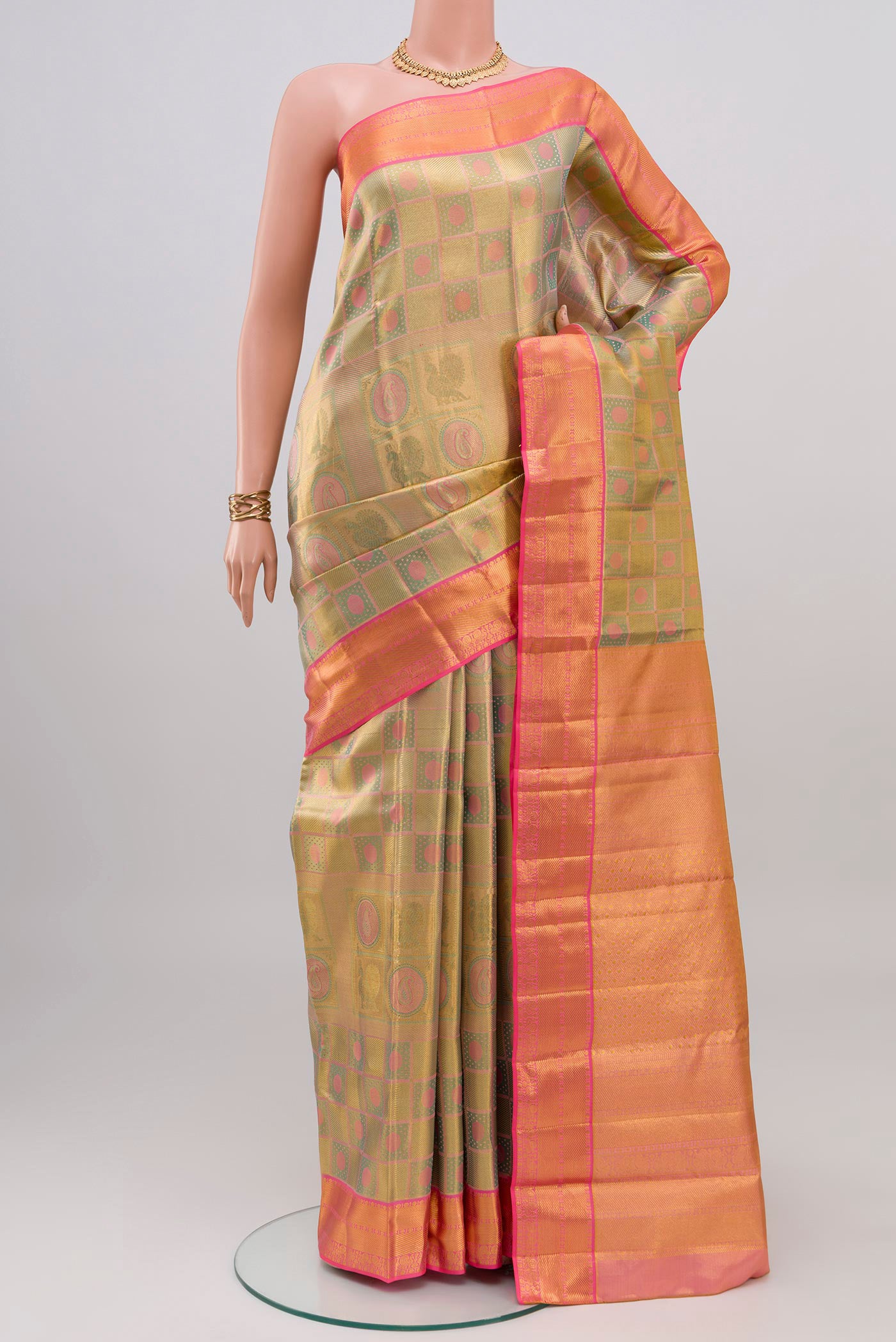 Golden Dual Tone Kanchipuram Tissue Silk Saree with Zari Brocade on the body and Zari Border.  displayed on a mannequin