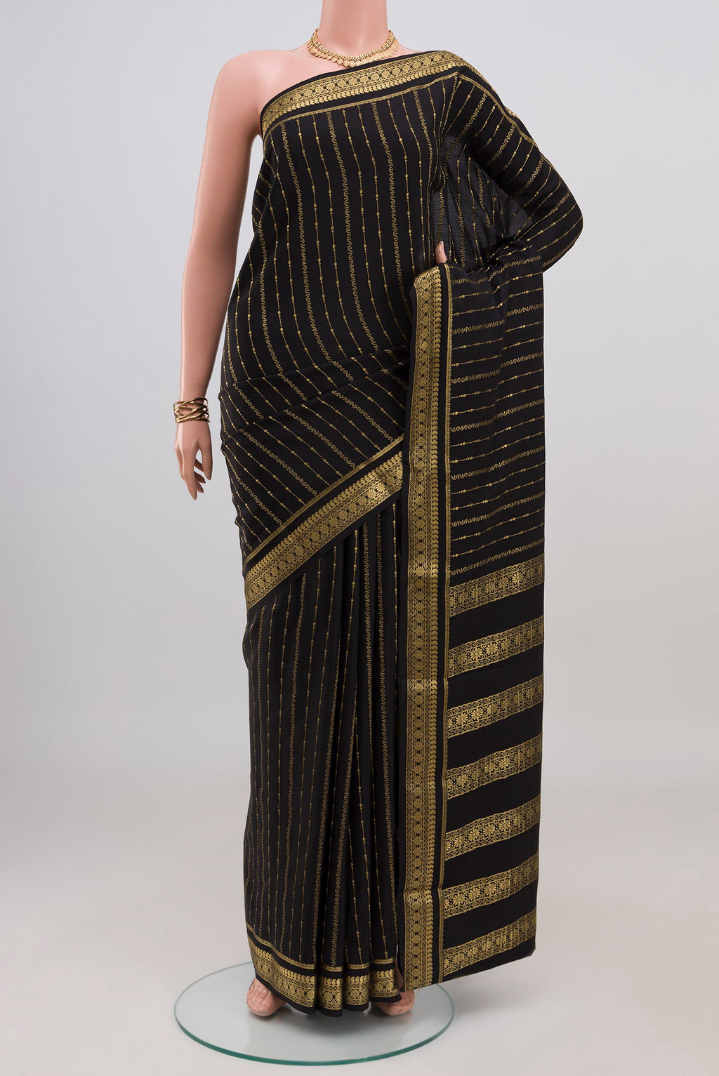 Black Mysore Crepe Saree with Stripes on the body and Zari Border.  displayed on a mannequin