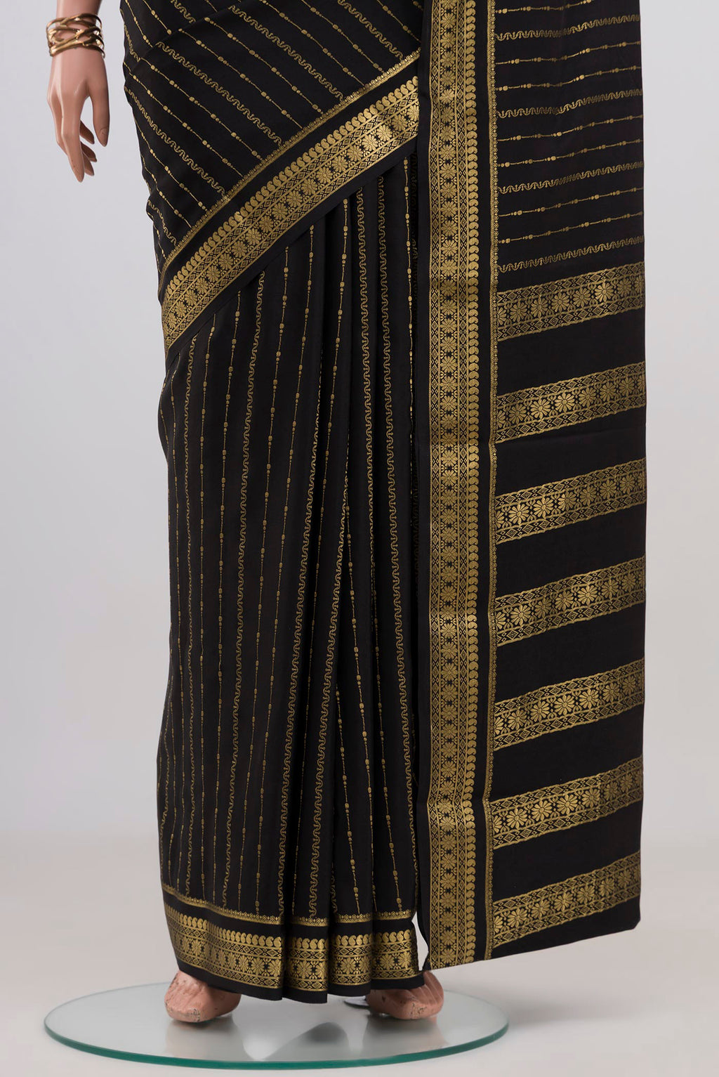 Pleats and pallu of Black Mysore Crepe Saree with Stripes on the body and Zari Border. 