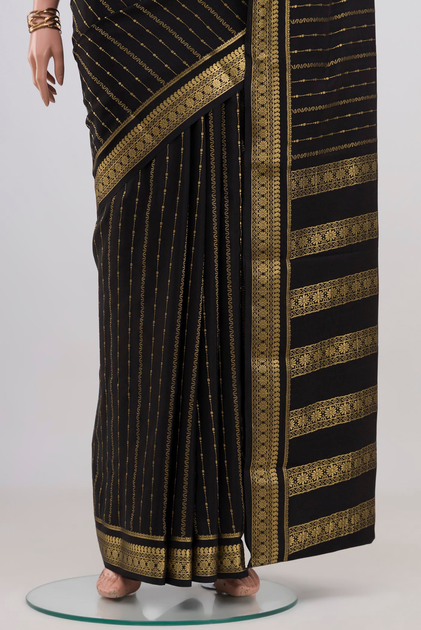 Pleats and pallu of Black Mysore Crepe Saree with Stripes on the body and Zari Border. 