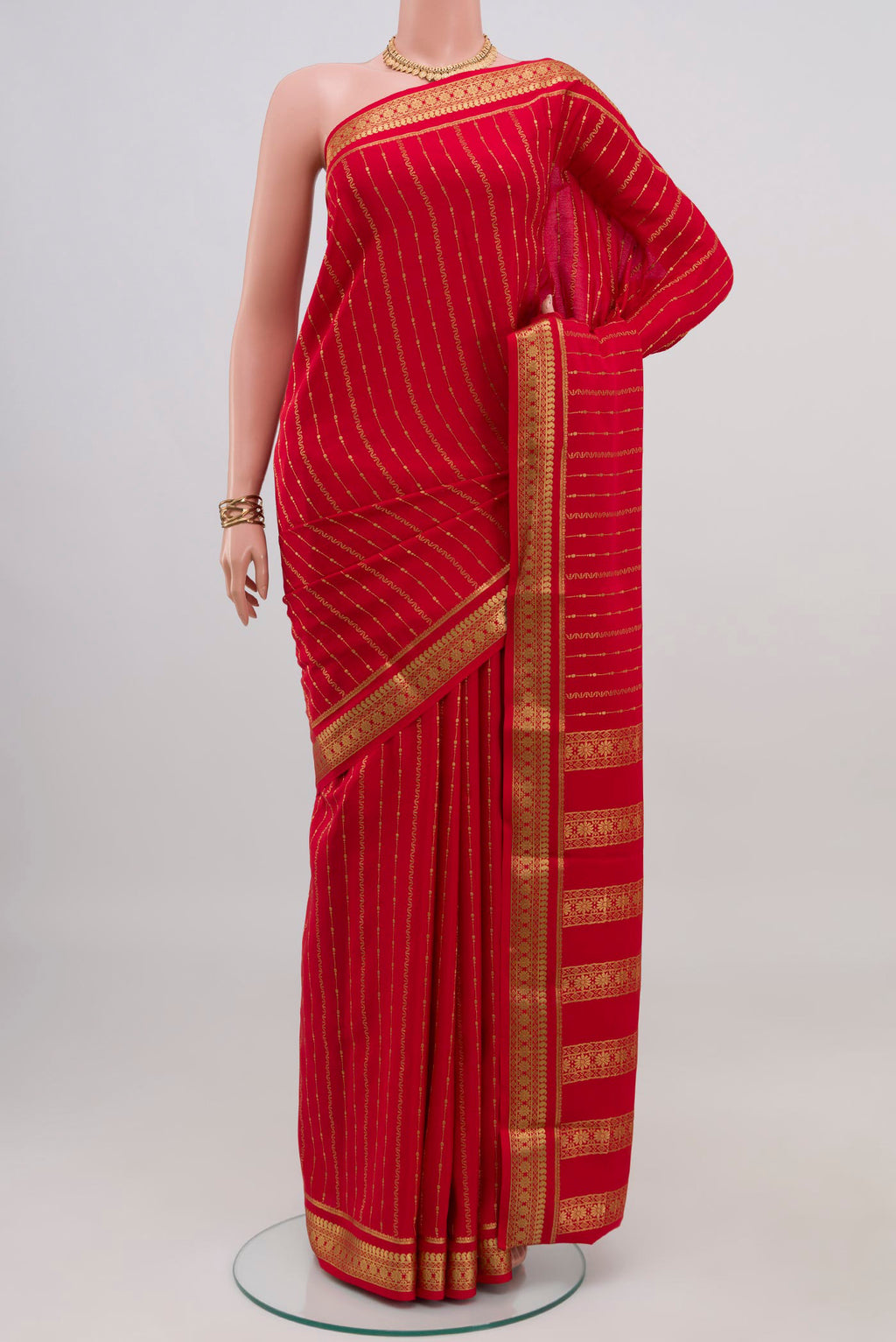 Red Mysore Crepe Saree with Stripes on the body and Zari Border.  displayed on a mannequin