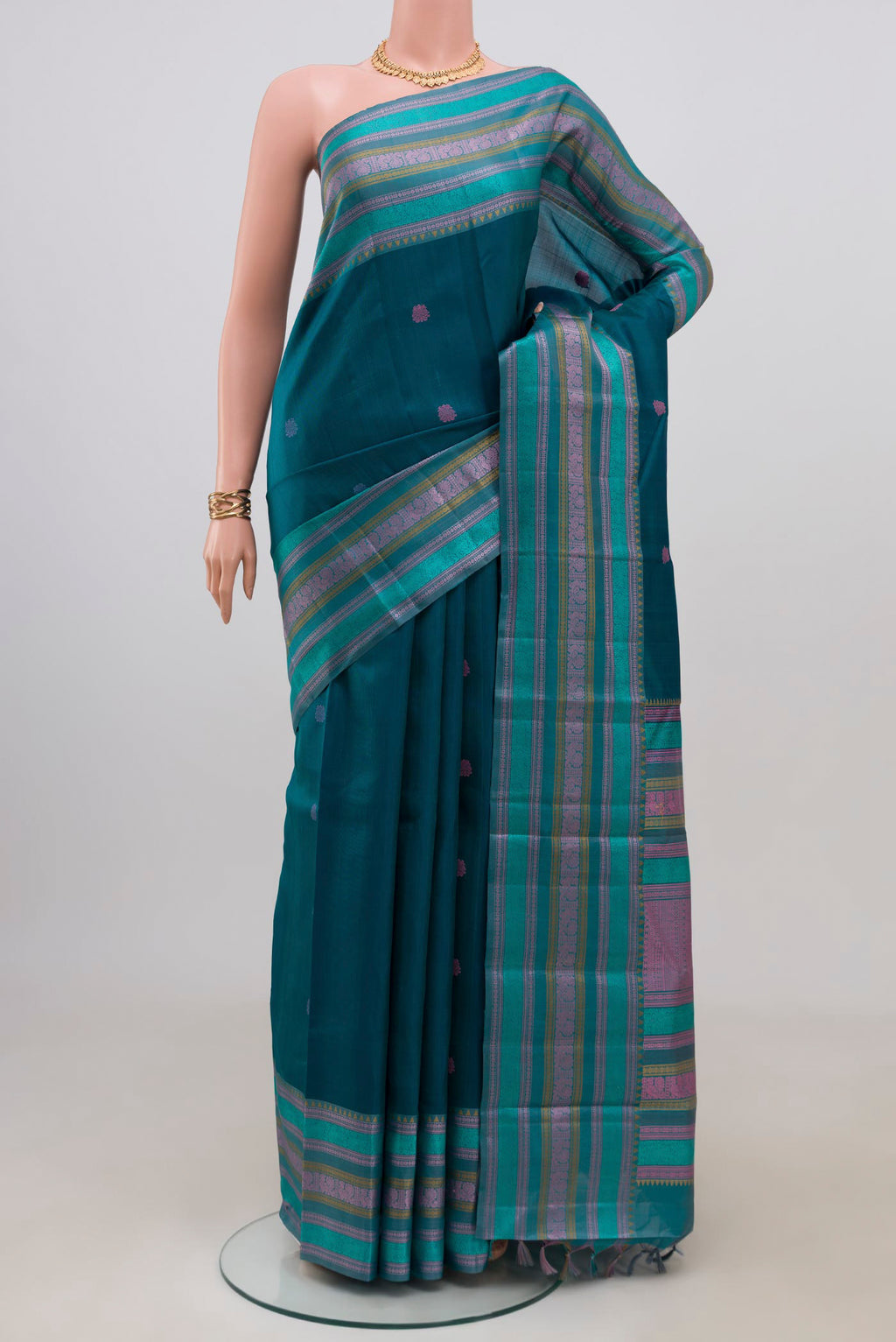 Blue Kanchipuram Silk Saree with Thread Butta on the body and Thread Border.  displayed on a mannequin