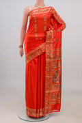Pure Silk Orange Baluchari Saree with Zari And Thread Butta on the body and Fancy Border.  displayed on a mannequin