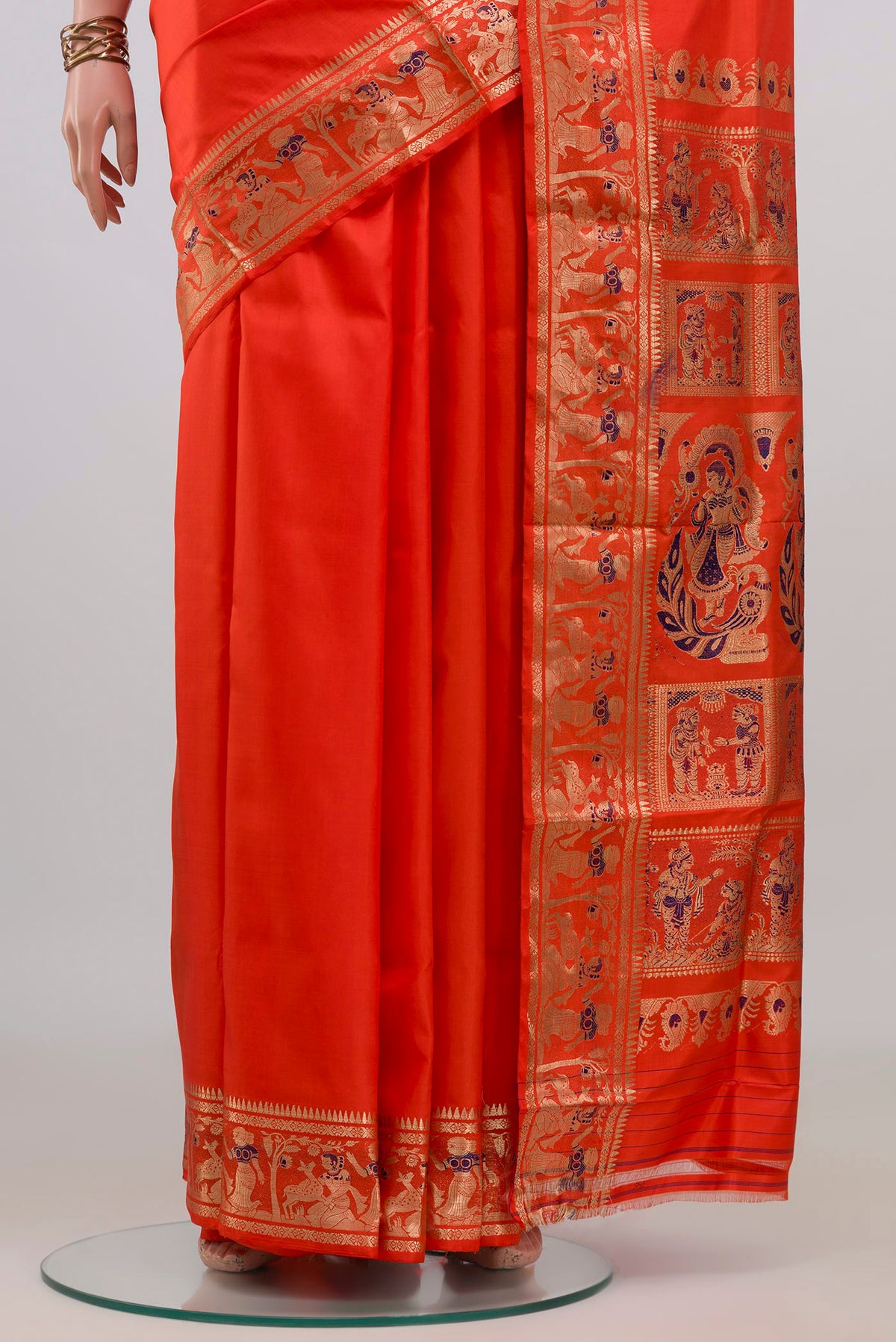 Pleats and pallu of Pure Silk Orange Baluchari Saree with Zari And Thread Butta on the body and Fancy Border. 