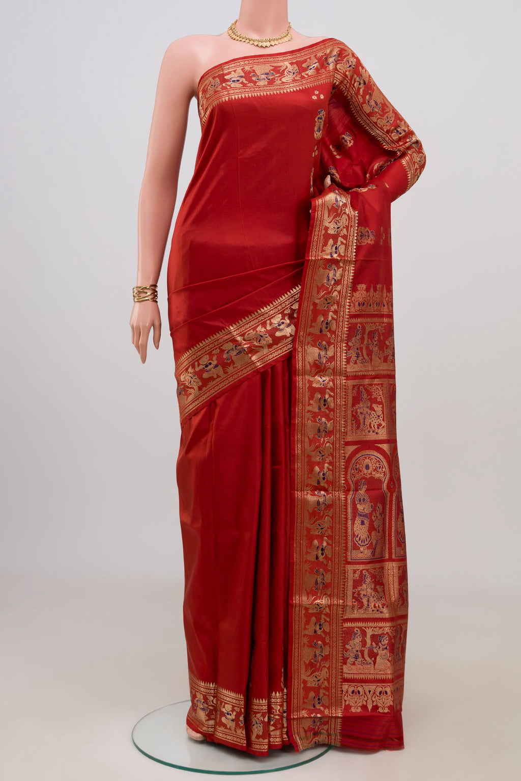Maroon Baluchari Silk Saree with Zari Butta on the body and Zari Border.  displayed on a mannequin