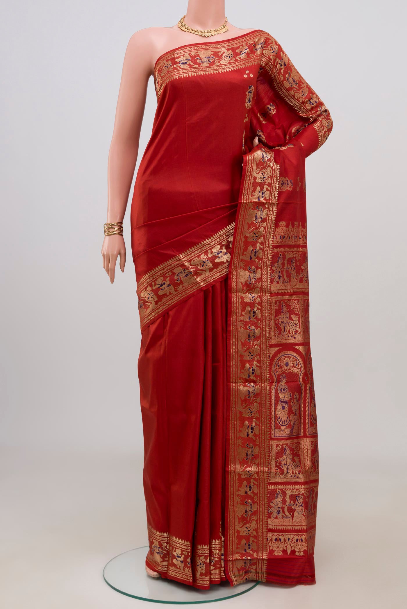 Maroon Baluchari Silk Saree with Zari Butta on the body and Zari Border.  displayed on a mannequin