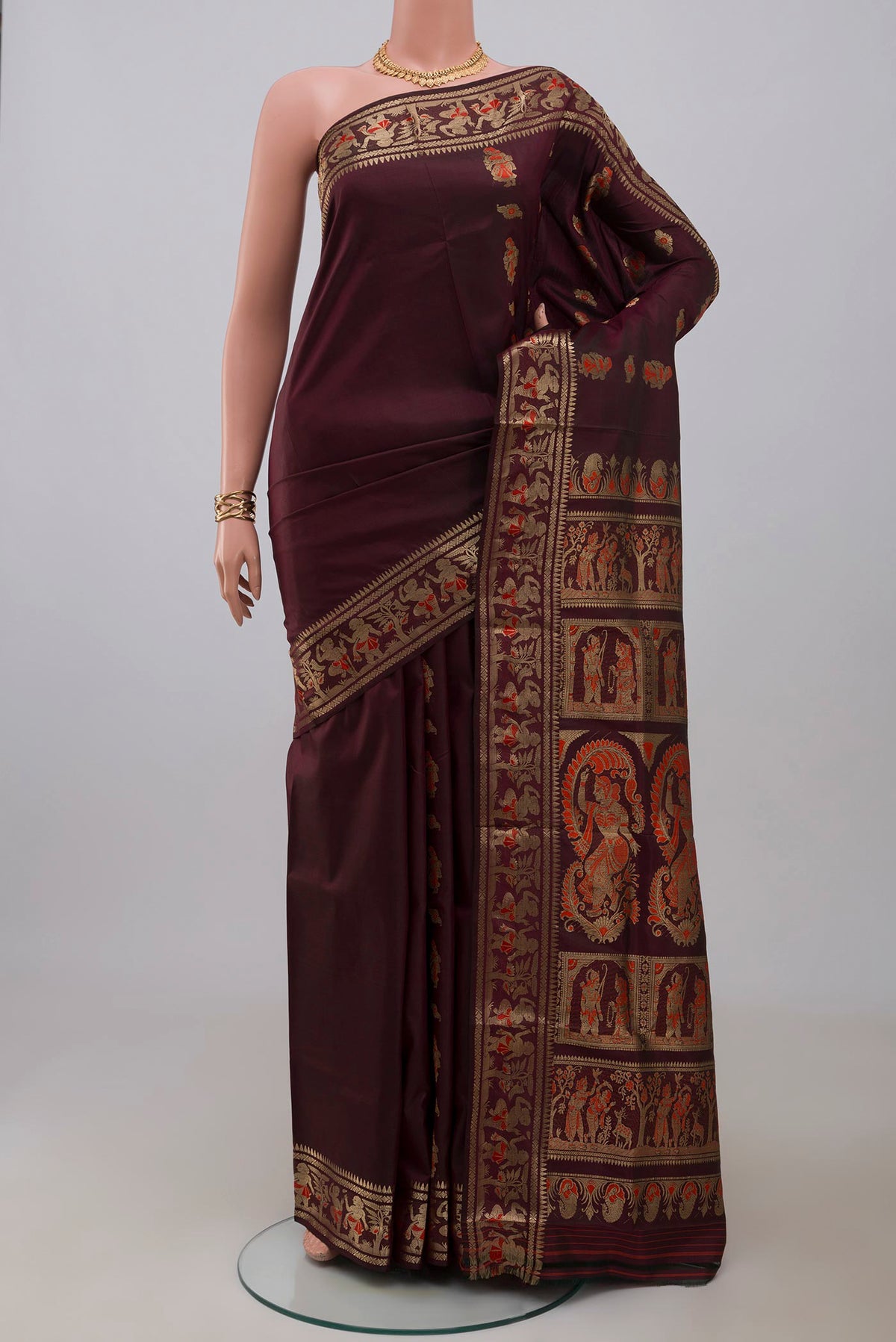 Coffee Brown Baluchari Silk Saree with Zari And Thread Butta on the body and Zari Border.  displayed on a mannequin