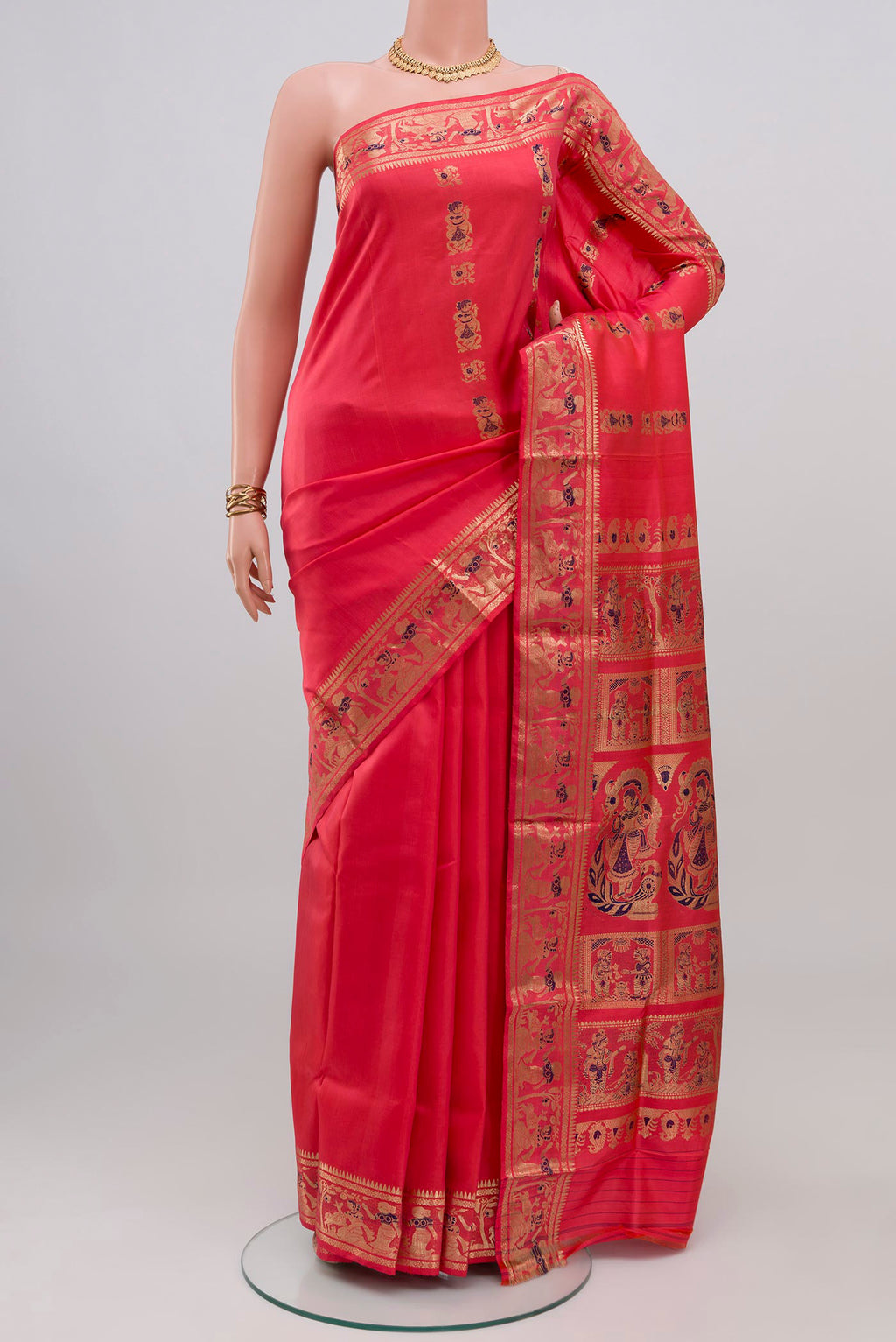 Coral Baluchari Silk Saree with Zari And Thread Butta on the body and Zari Border.  displayed on a mannequin