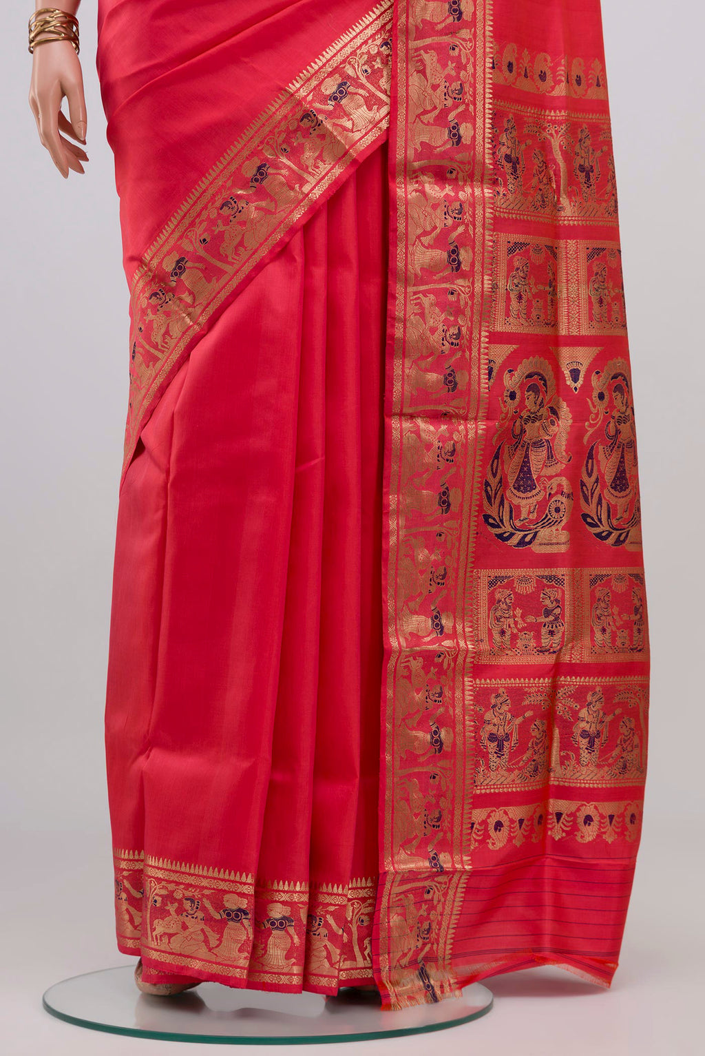 Pleats and pallu of Coral Baluchari Silk Saree with Zari And Thread Butta on the body and Zari Border. 