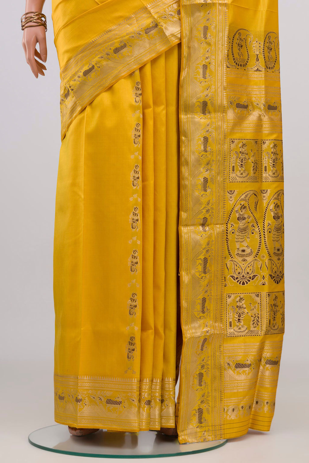 Pleats and pallu of Yellow Baluchari Silk Saree with Zari And Thread Butta on the body and Zari Border. 