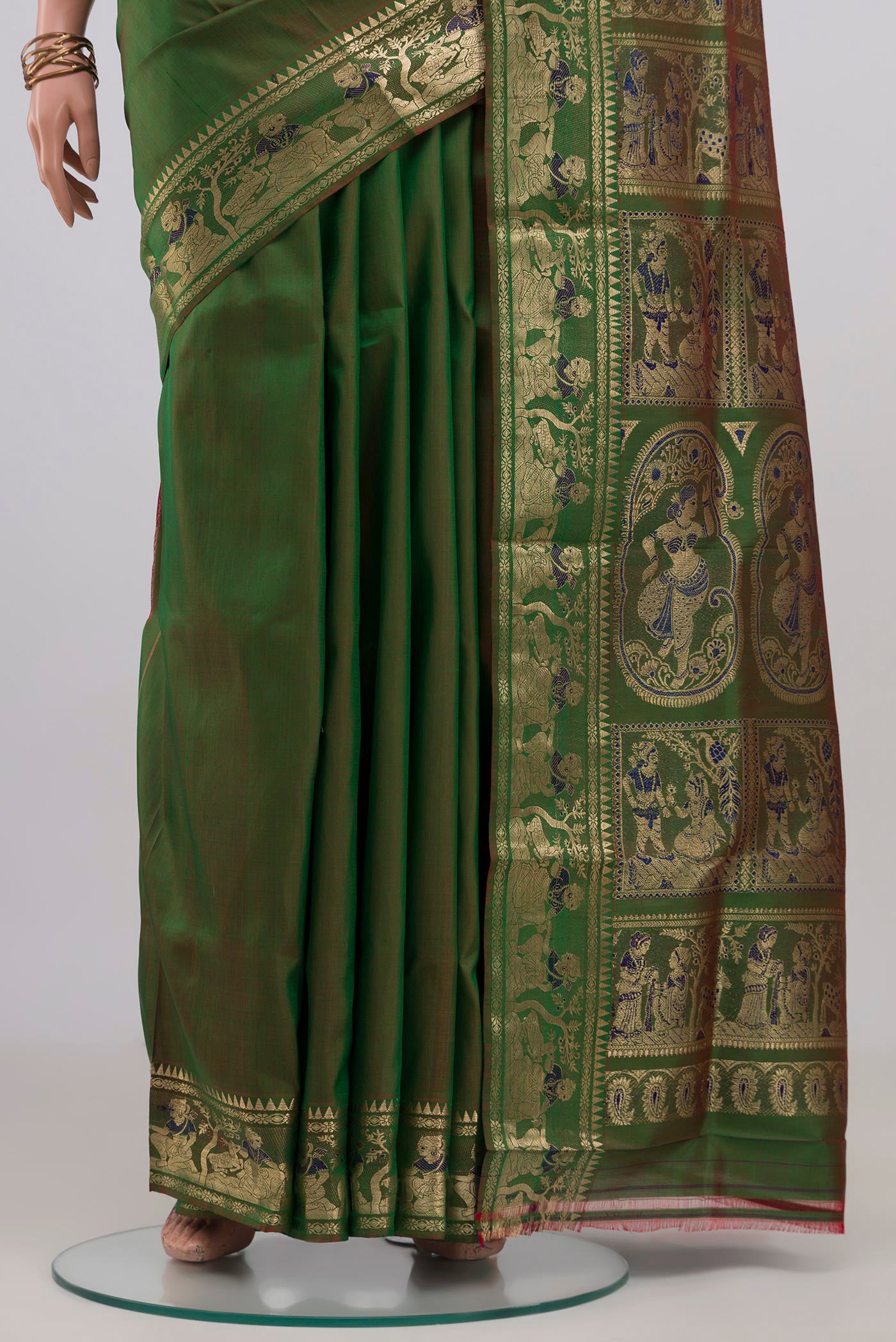 Pleats and pallu of Green Baluchari Silk Saree with Plain Body and Zari Border. 