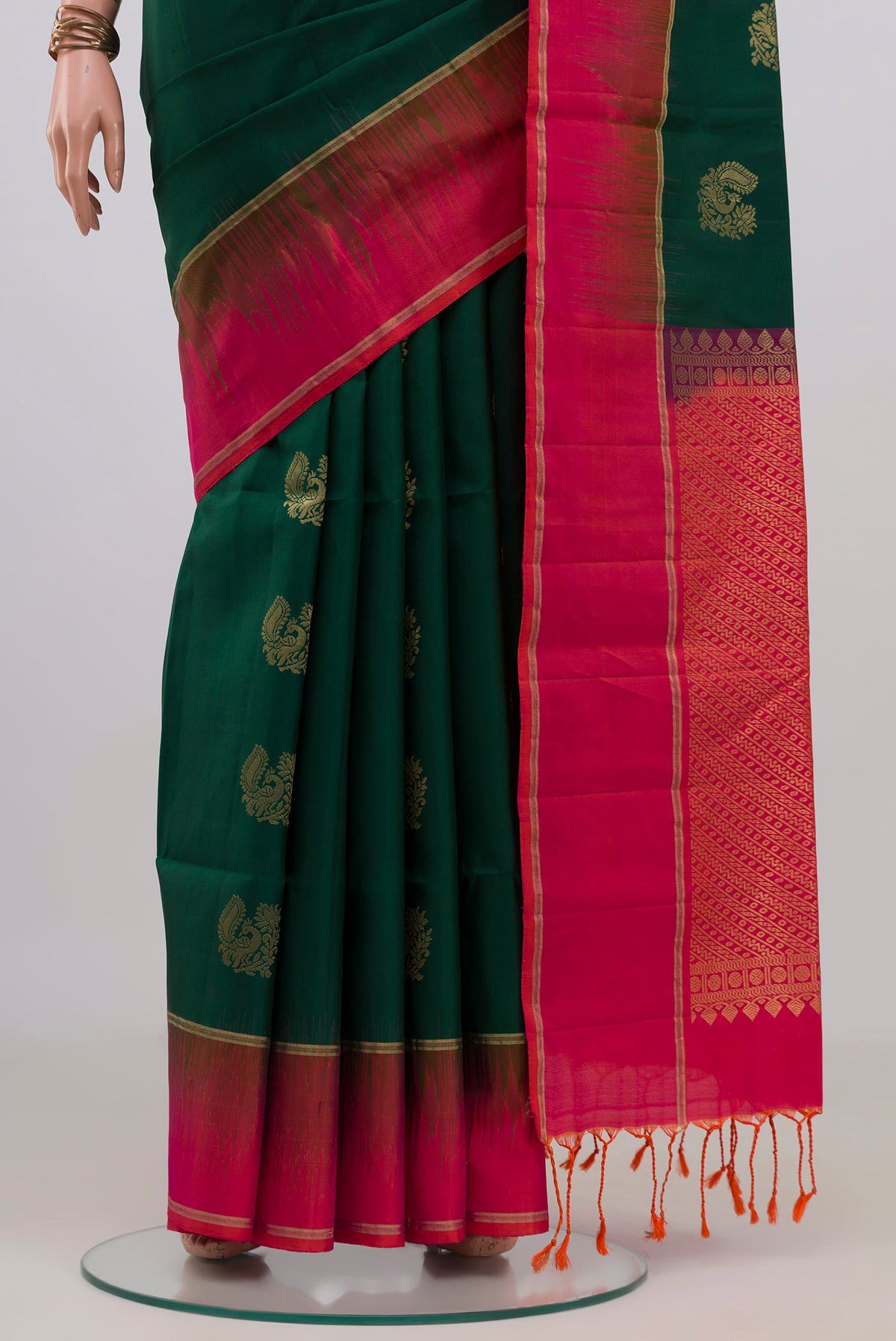 Pleats and pallu of Pure Silk Bottle Green Soft Saree with Zari Butta on the body and Plain Border. 