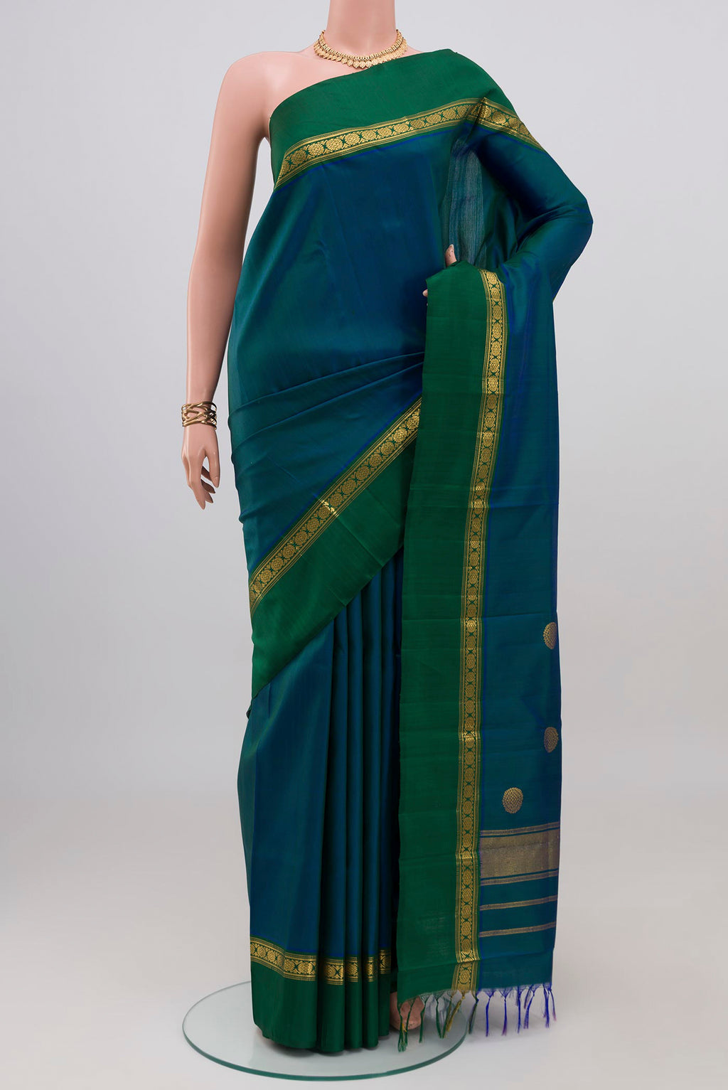 Peacock Blue Kanjivaram Silk Saree with Plain Body and Zari Border.  displayed on a mannequin