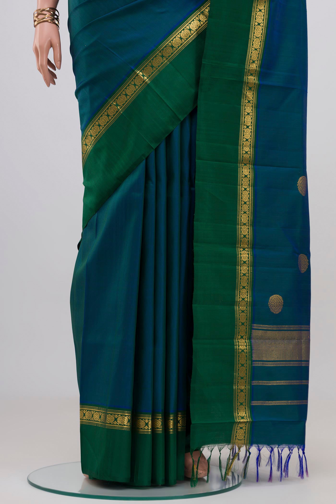 Pleats and pallu of Peacock Blue Kanjivaram Silk Saree with Plain Body and Zari Border. 