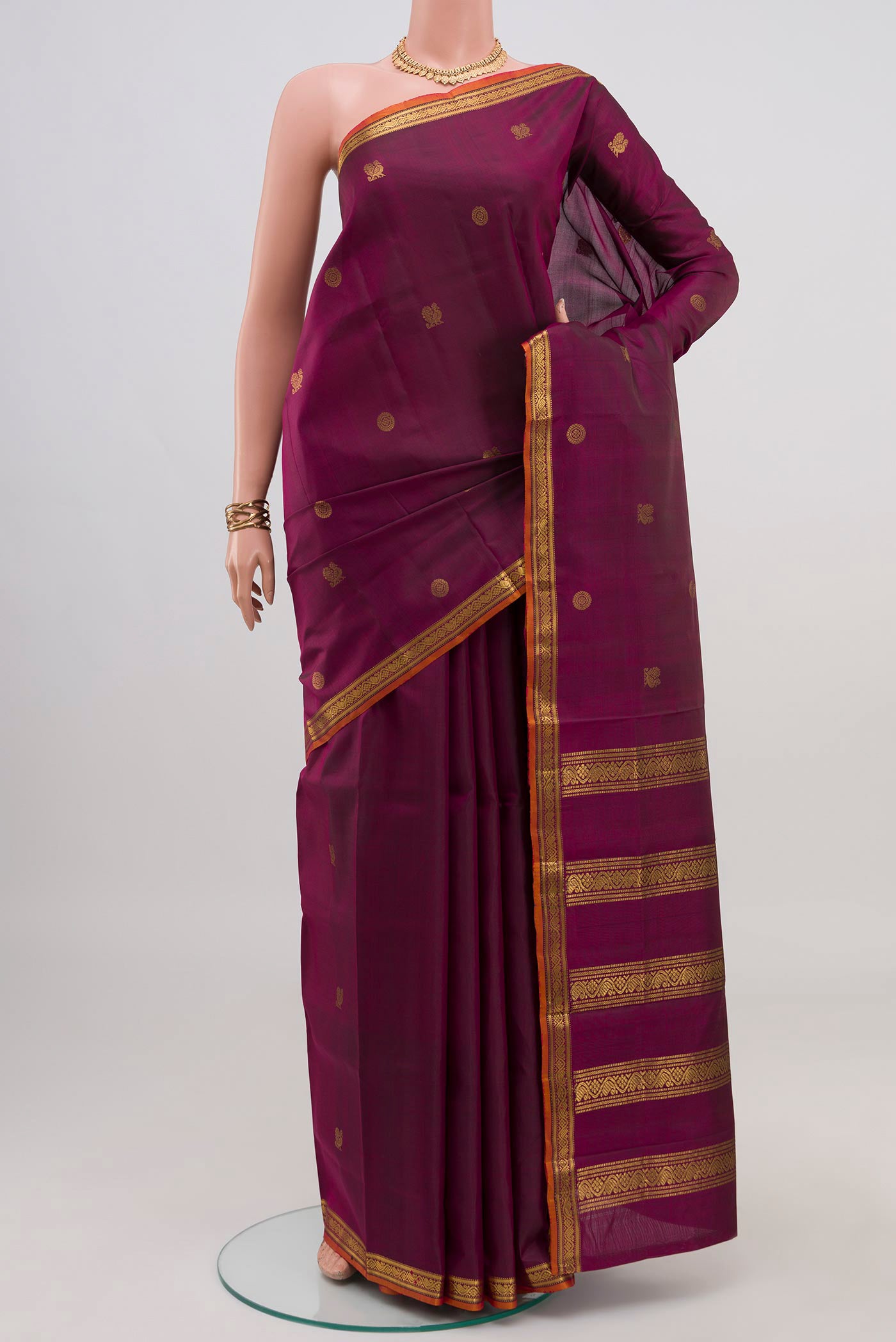 Pure Silk Pure Zari Purple Kanchipuram Saree with Zari Butta on the body and Zari Border.  displayed on a mannequin