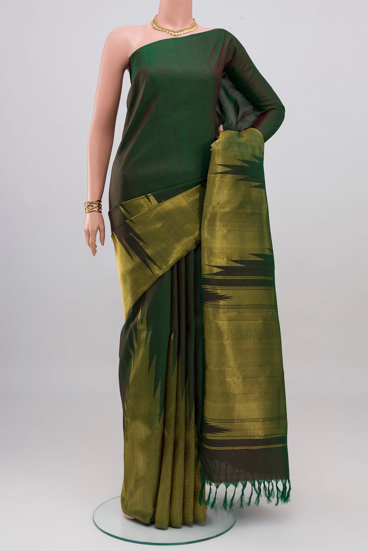 Bottle Green Kanjivaram Silk Saree with Plain Body and Rising Temple Border.  displayed on a mannequin