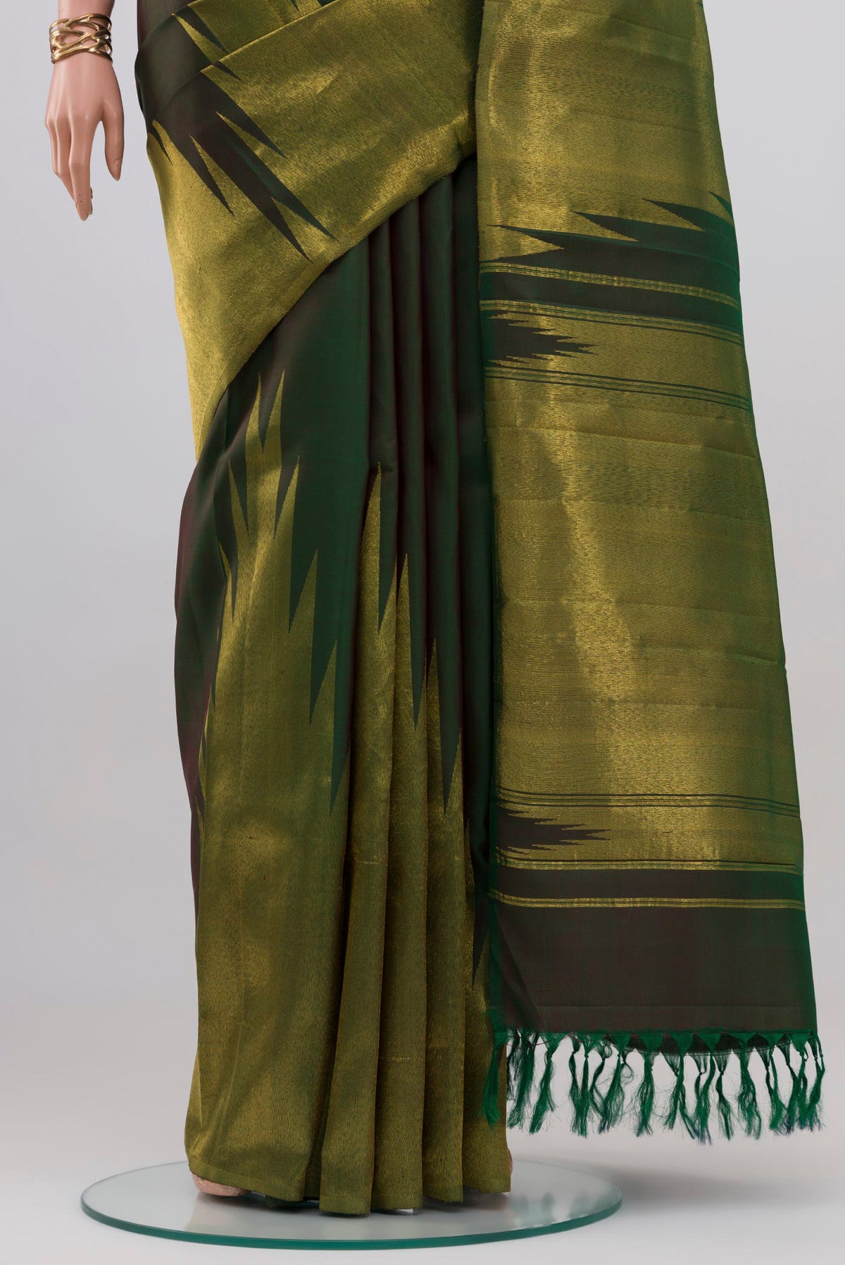 Pleats and pallu of Bottle Green Kanjivaram Silk Saree with Plain Body and Rising Temple Border. 