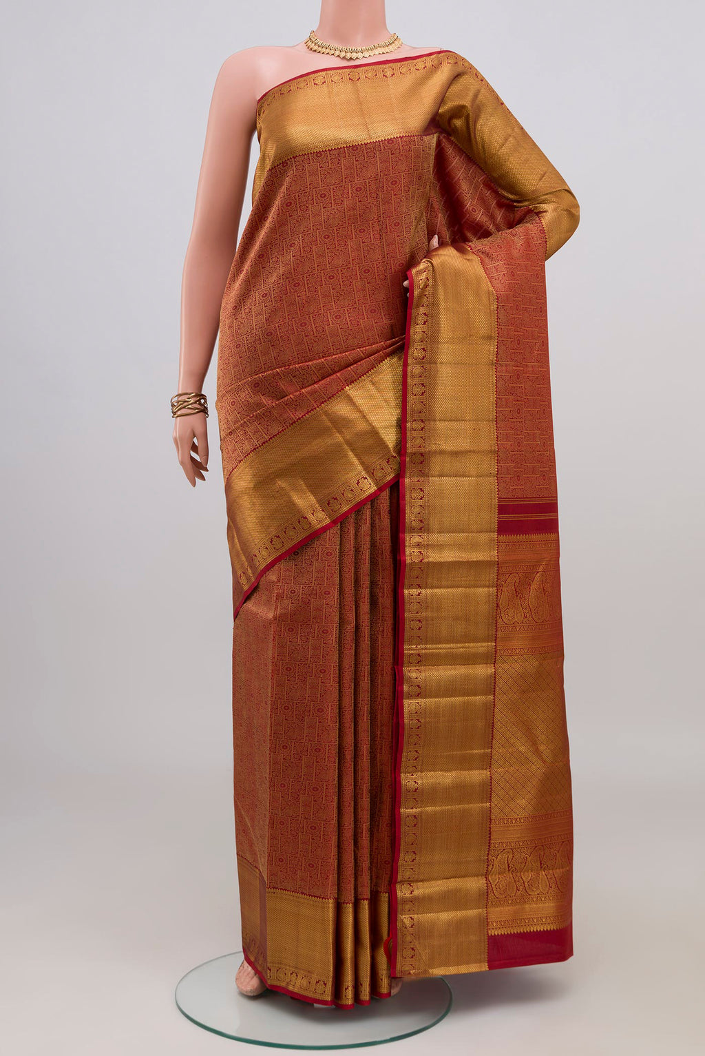 Maroon Kanjivaram Silk Saree with Zari Brocade on the body and Zari Border.  displayed on a mannequin