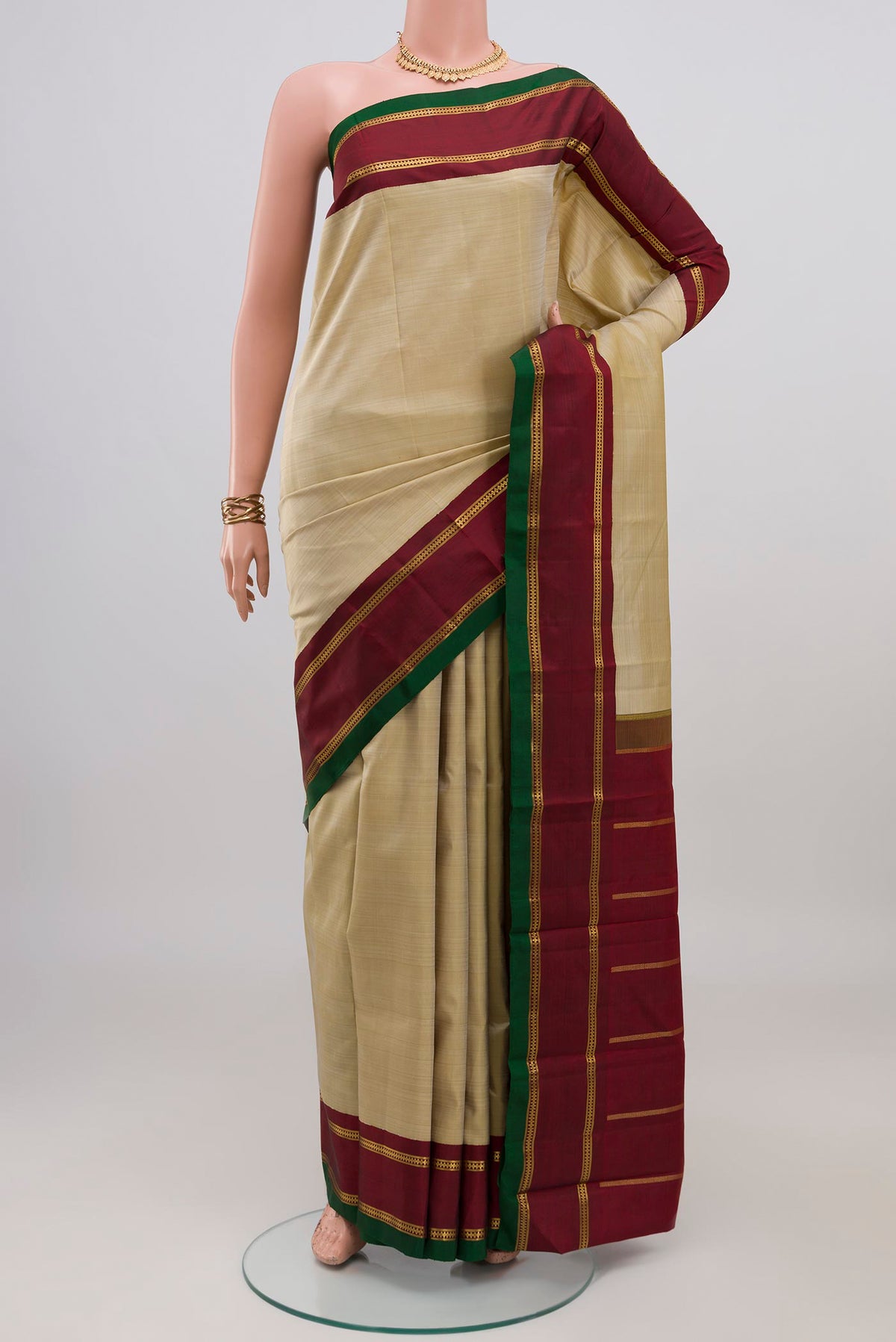 Pure Silk Pure Zari Cream Kanjivaram Saree with Plain Body and Zari Border.  displayed on a mannequin