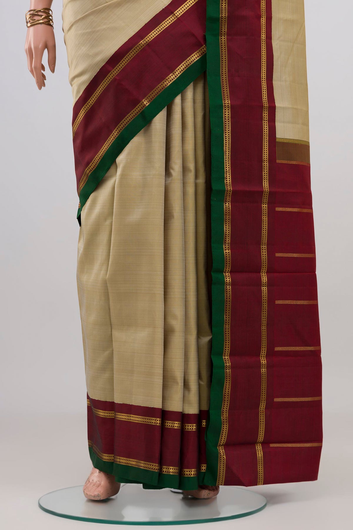 Pleats and pallu of Pure Silk Pure Zari Cream Kanjivaram Saree with Plain Body and Zari Border. 