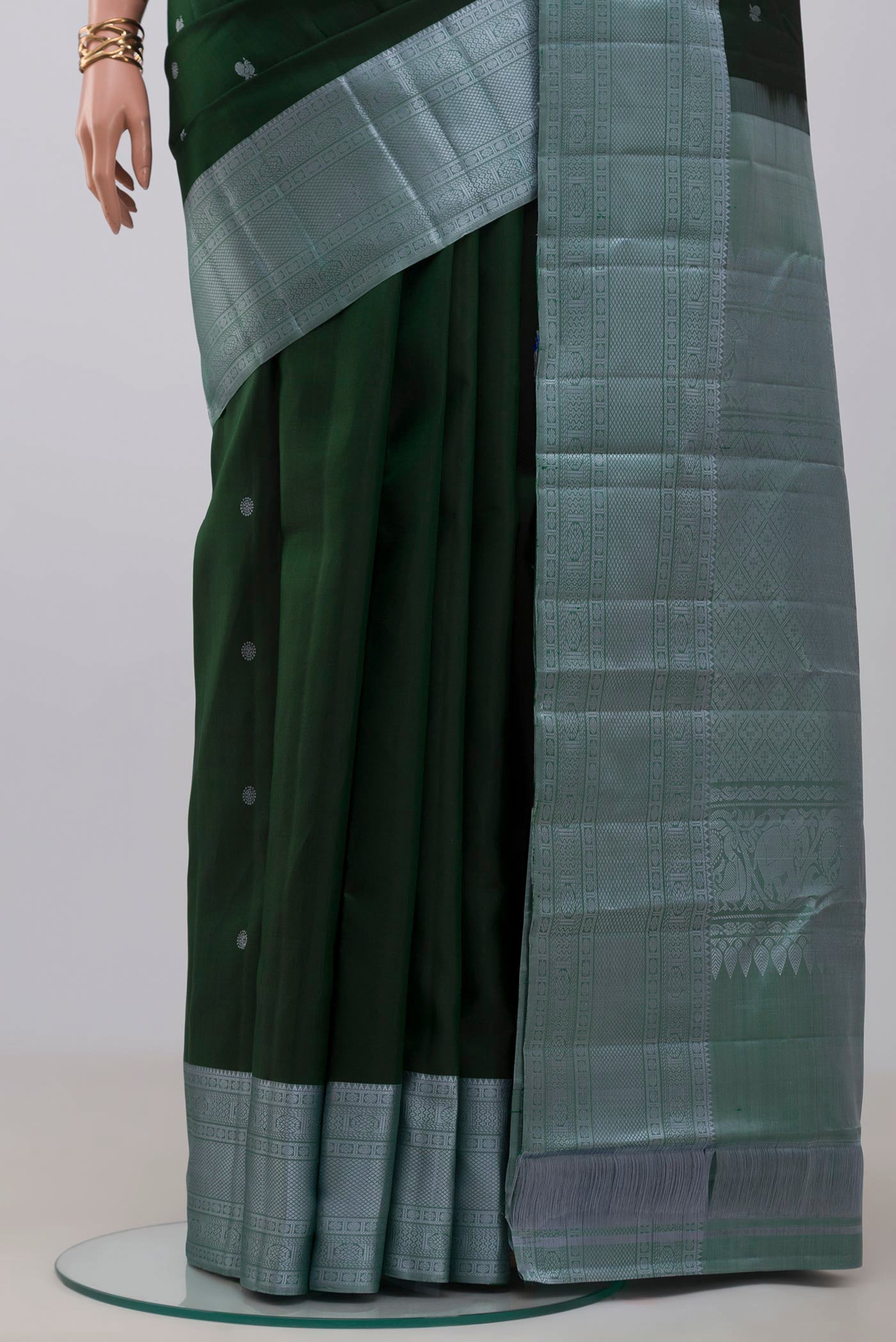 Pleats and pallu of Bottle Green Kanchipuram Silk Saree with Thread Butta on the body and Thread Border. 
