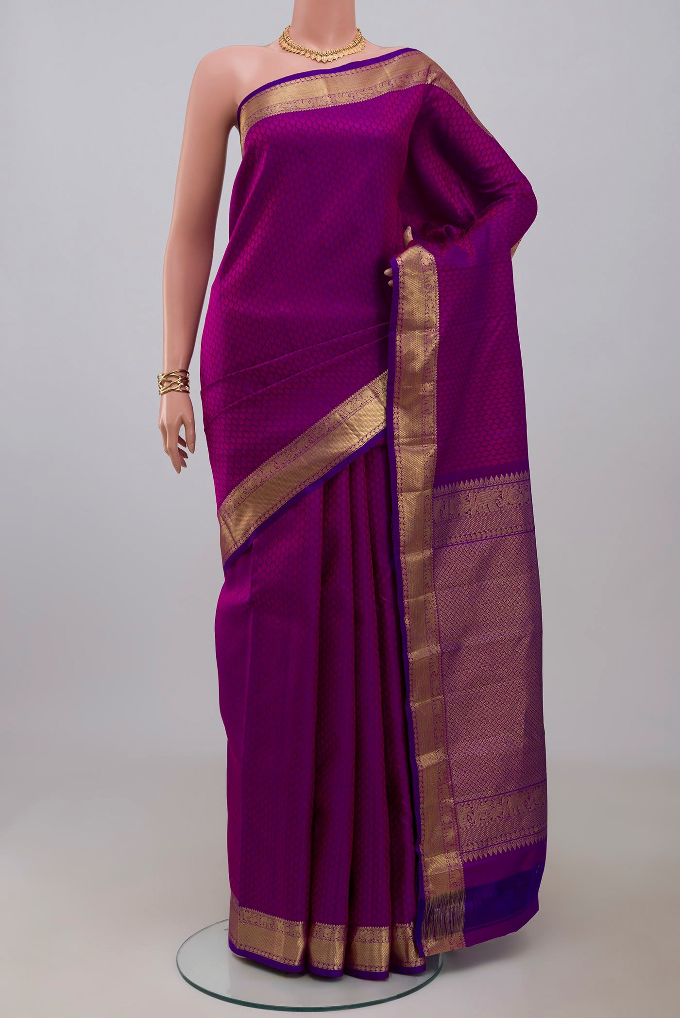 Purple Kanjivaram Silk Saree with Jacquard design on the body and Zari Border.  displayed on a mannequin