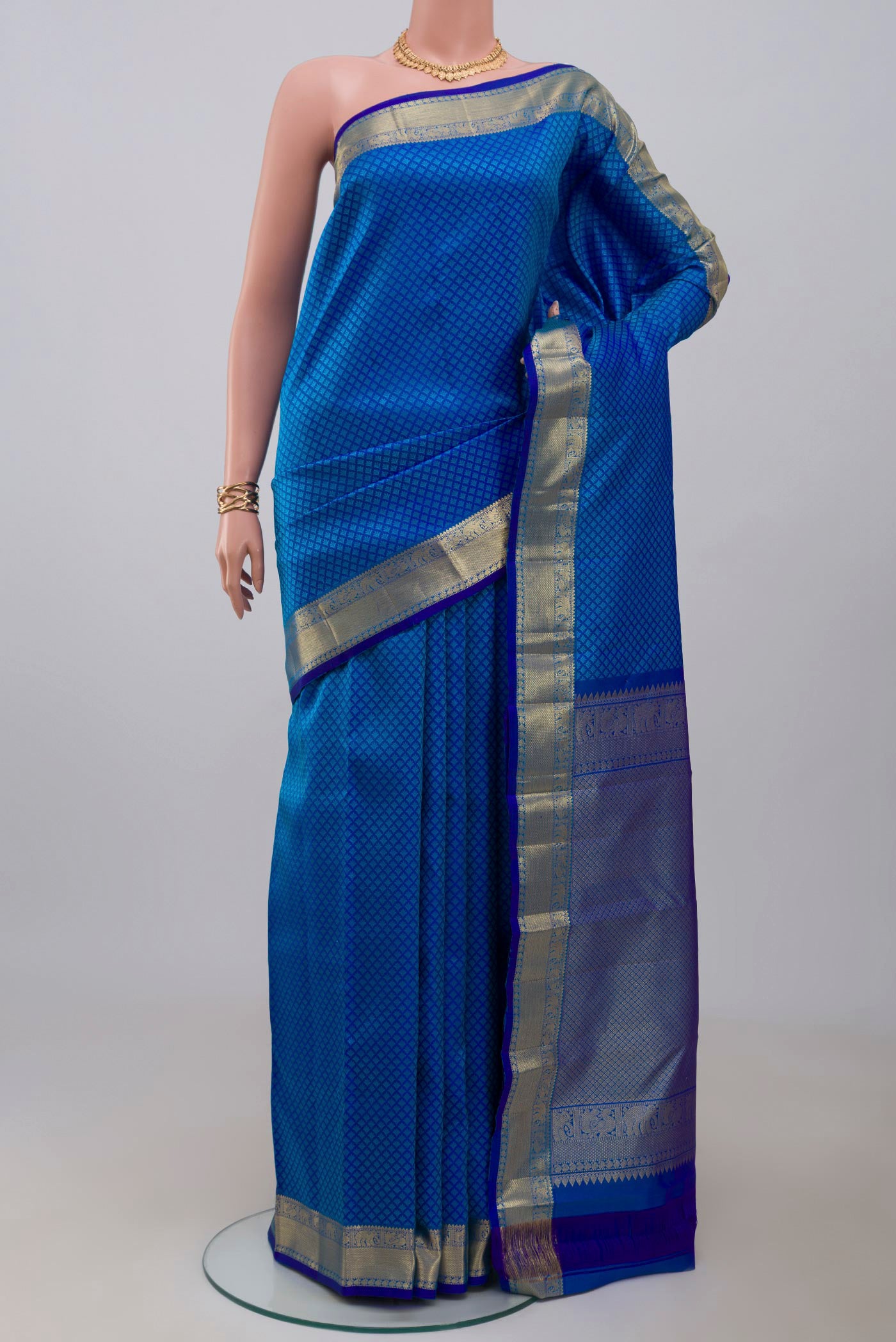 Royal Blue Kanjivaram Silk Saree with Jacquard design on the body and Zari Border.  displayed on a mannequin