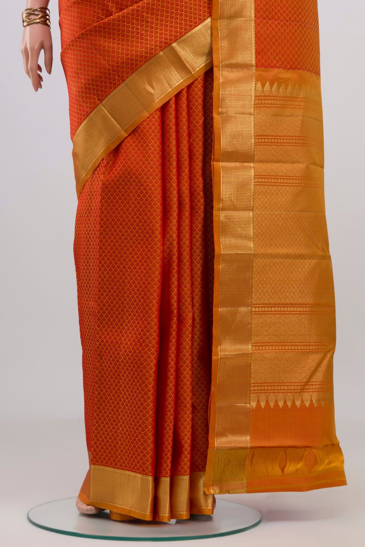 Pleats and pallu of Brick Orange Kanjivaram Silk Saree with Jacquard design on the body and Zari Border. 