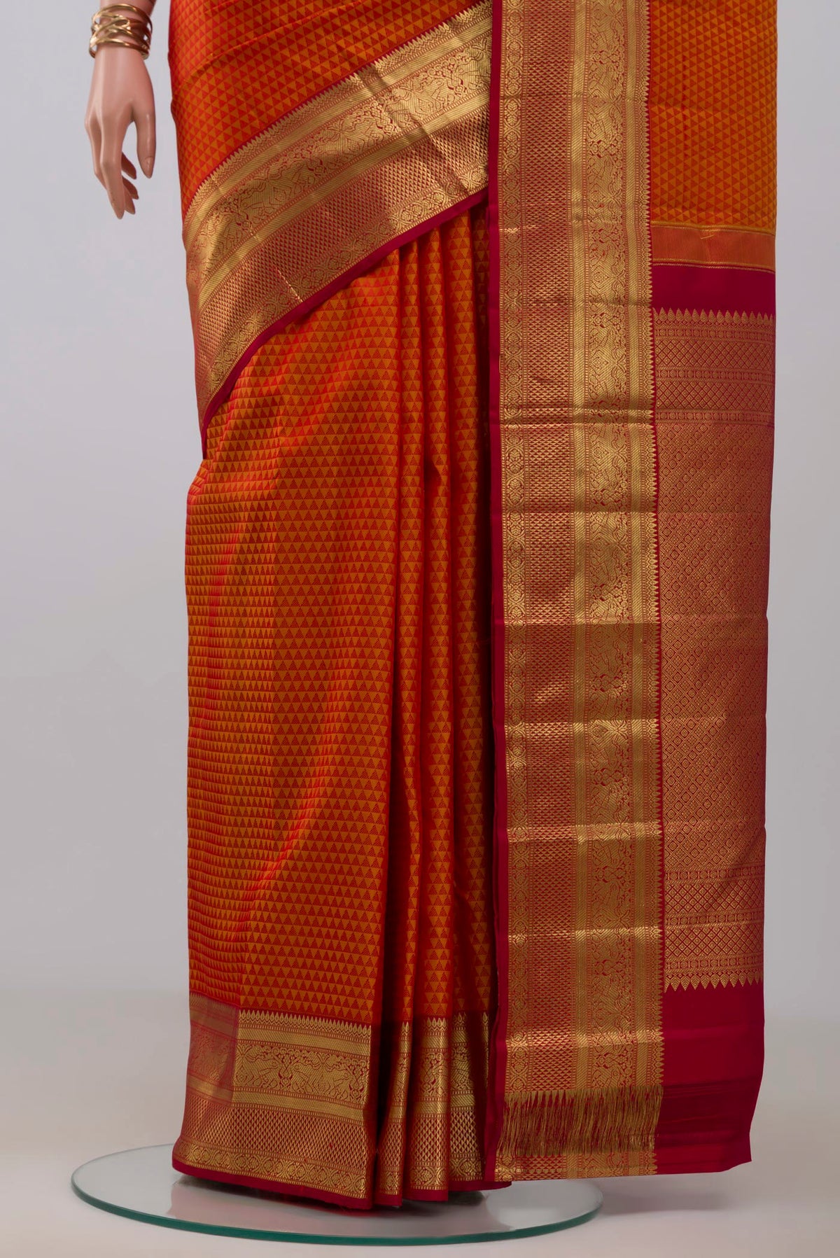 Pleats and pallu of Orange Kanjivaram Silk Saree with Jacquard design on the body and Zari Border. 