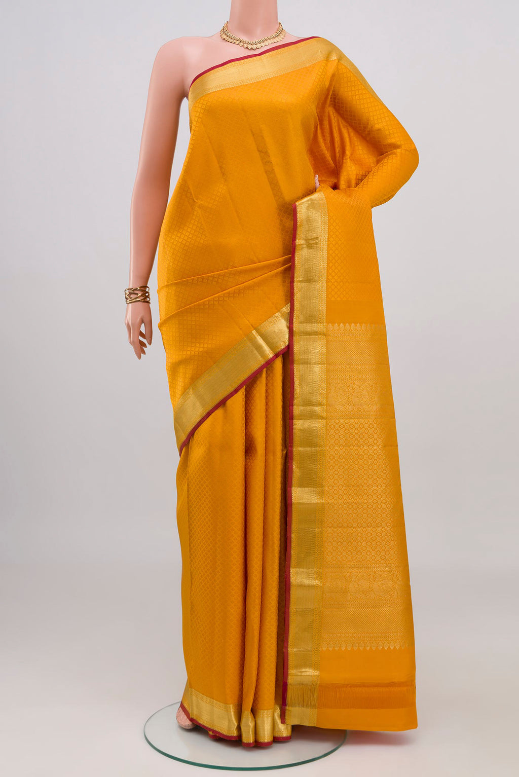 Yellow Kanjivaram Silk Saree with Jacquard design on the body and Zari Border.  displayed on a mannequin